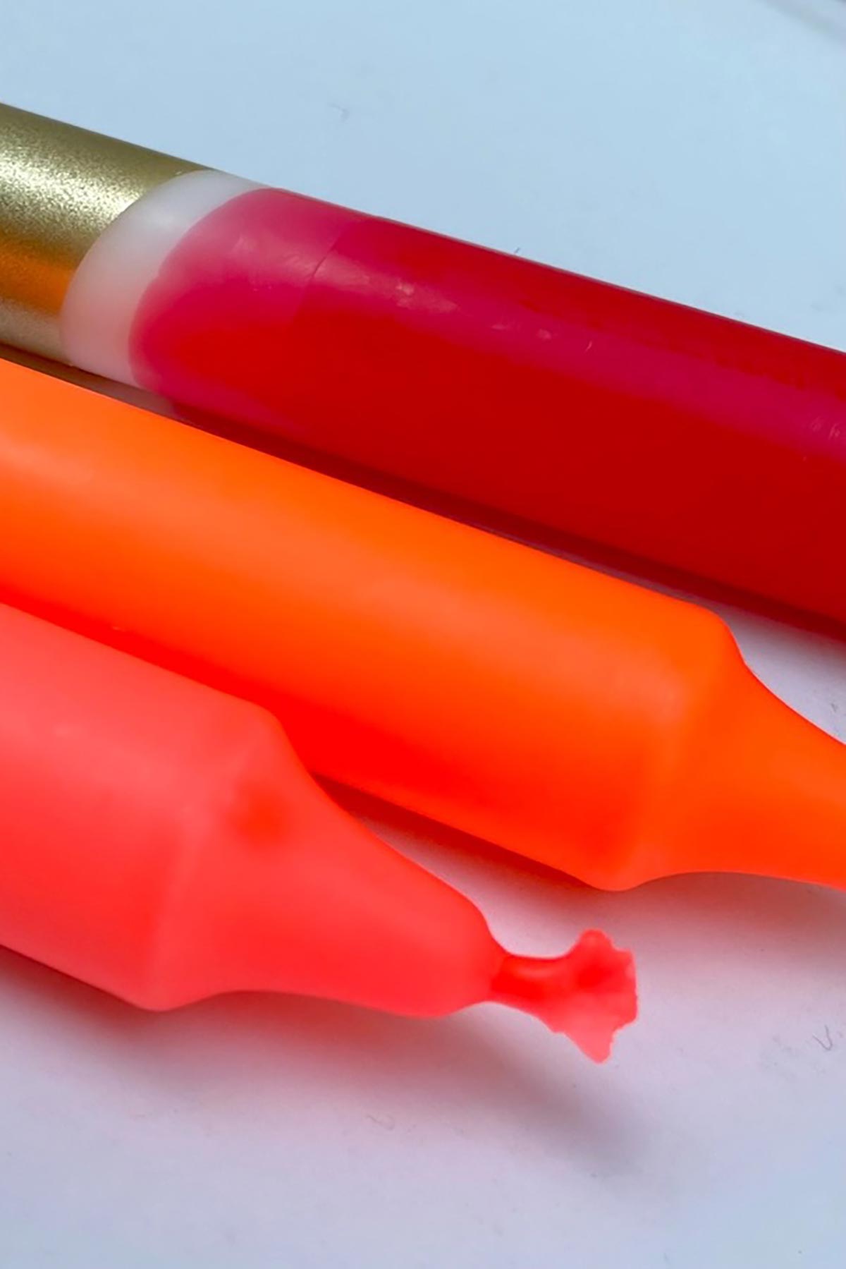 The Singing Rabbit Red, Neon Coral, Neon Orange & Gold Dip Dyed Dinner Candles Set Of 3