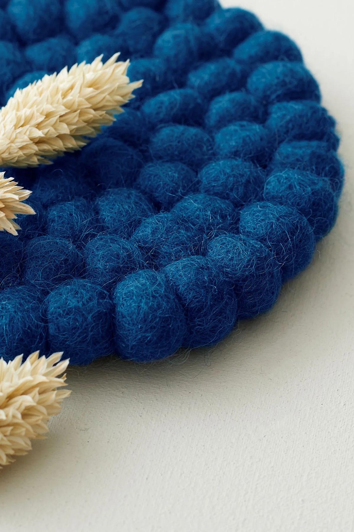 Felt coaster used under mug/vase in moody blue