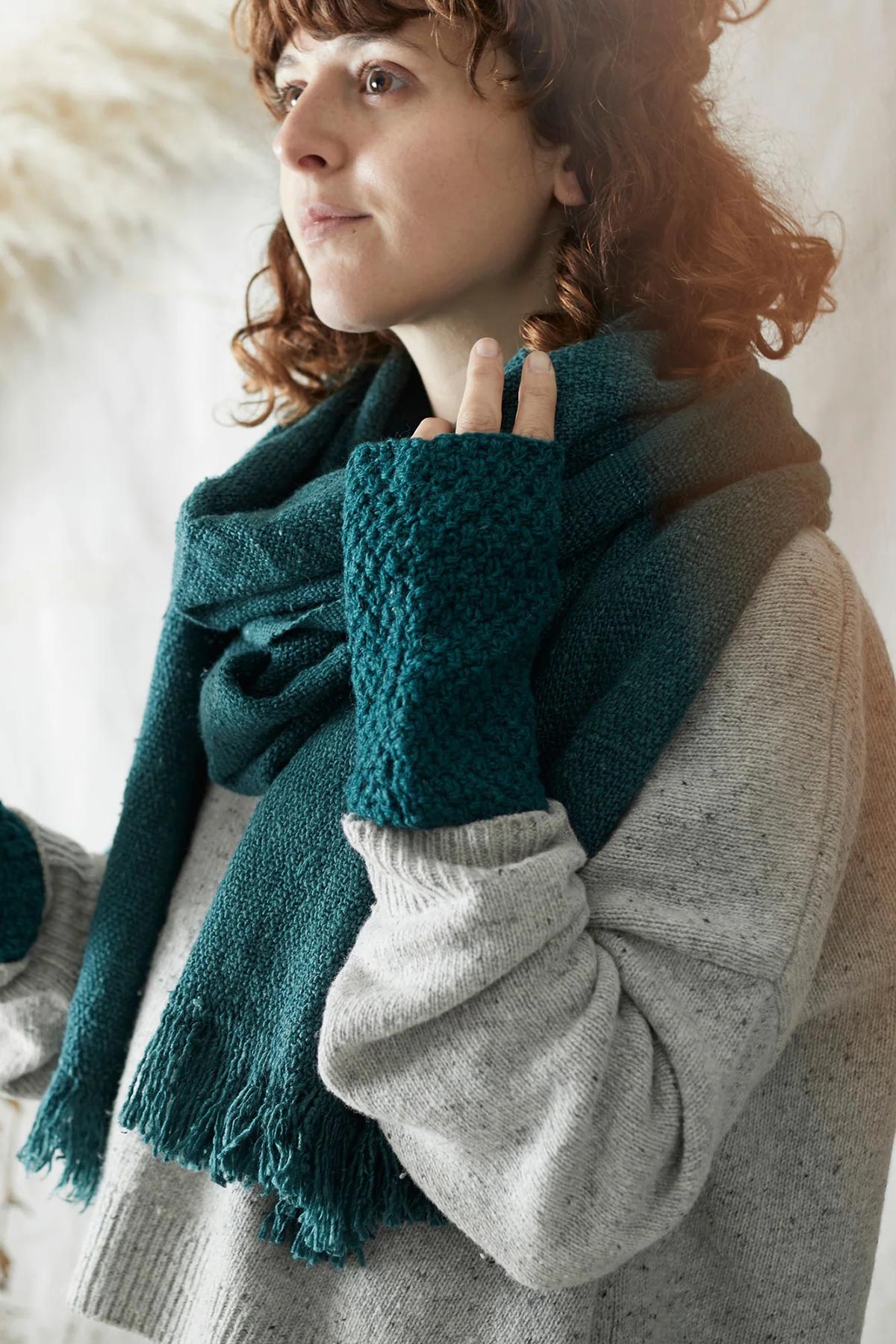 Model wearing Aura Que Bibek scarf in teal green