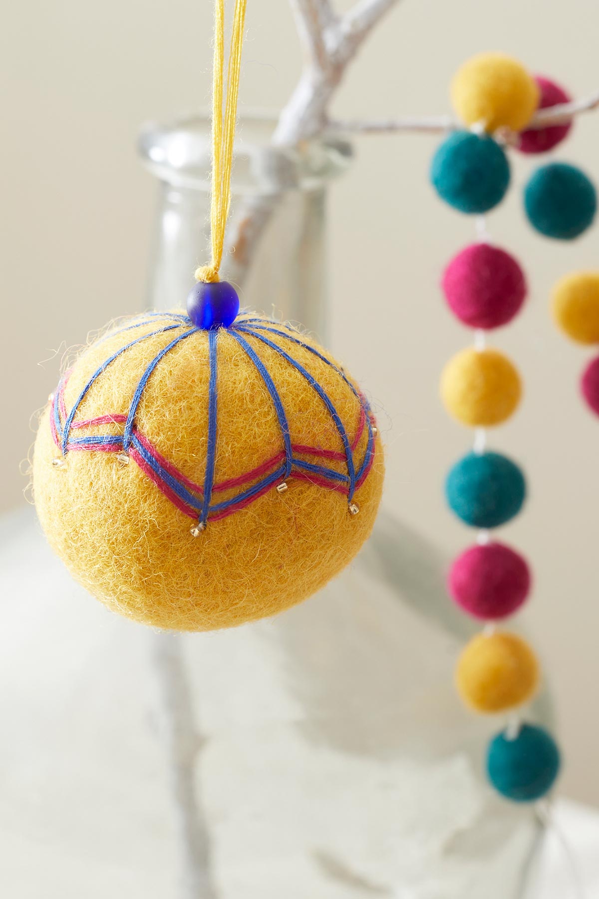 Hanging felt bauble in mustard yellow