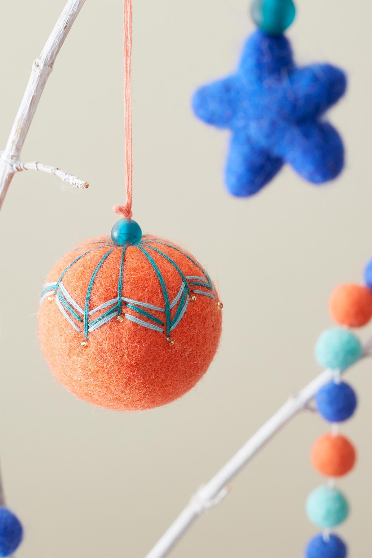 Hanging felt bauble in sunrise orange