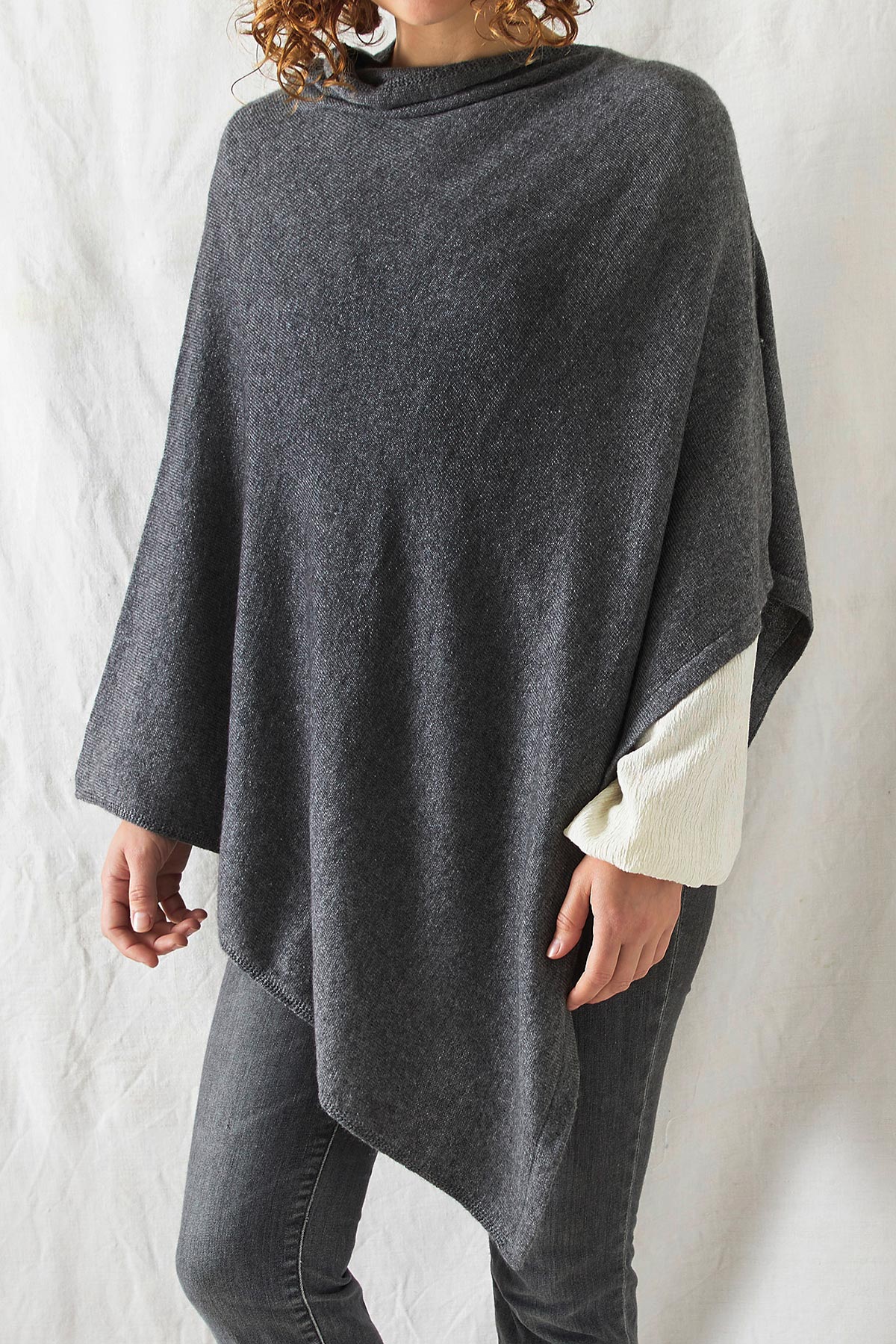 Model wearing Risi merino poncho in charcoal grey