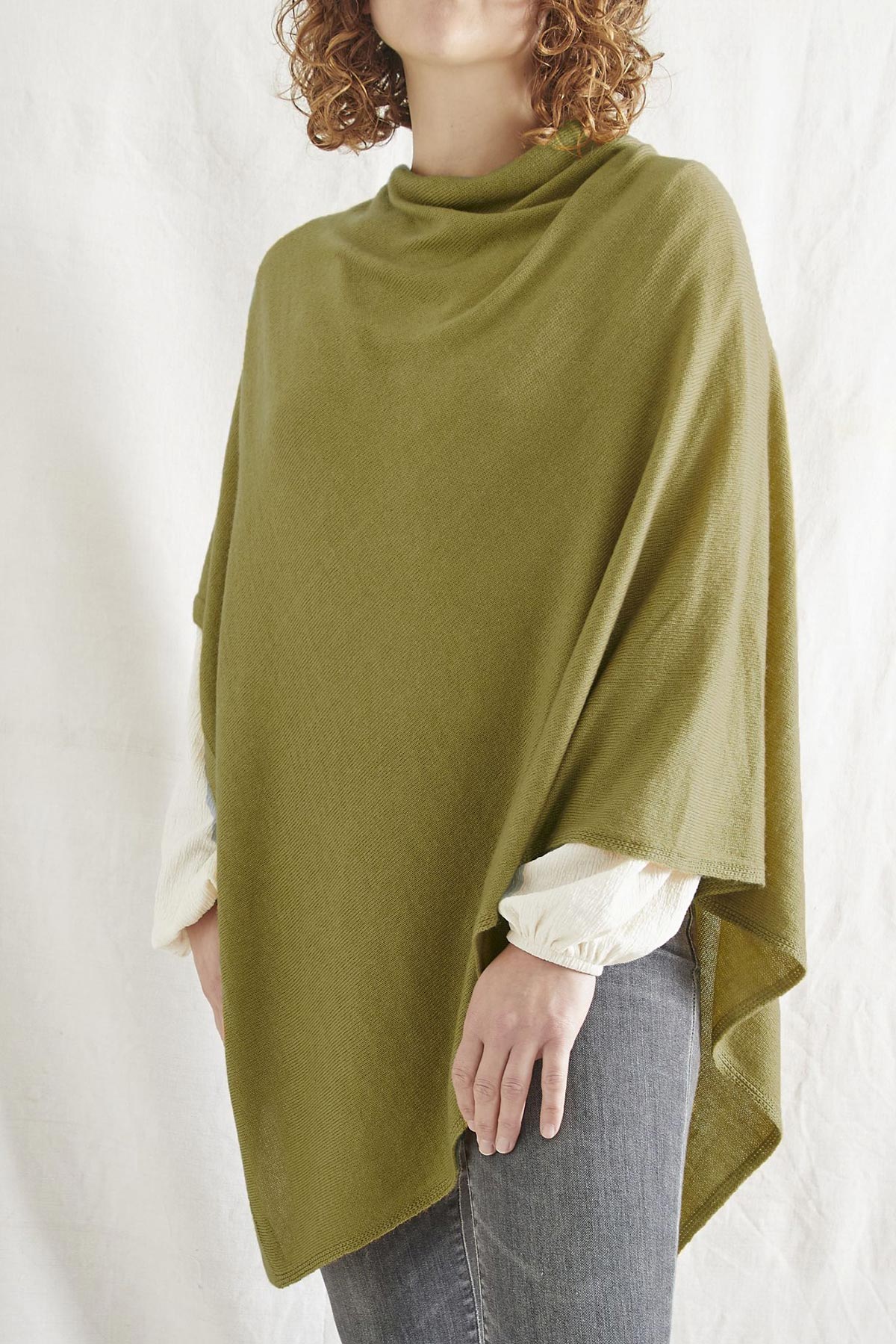 Model wearing Risi merino poncho in olive green