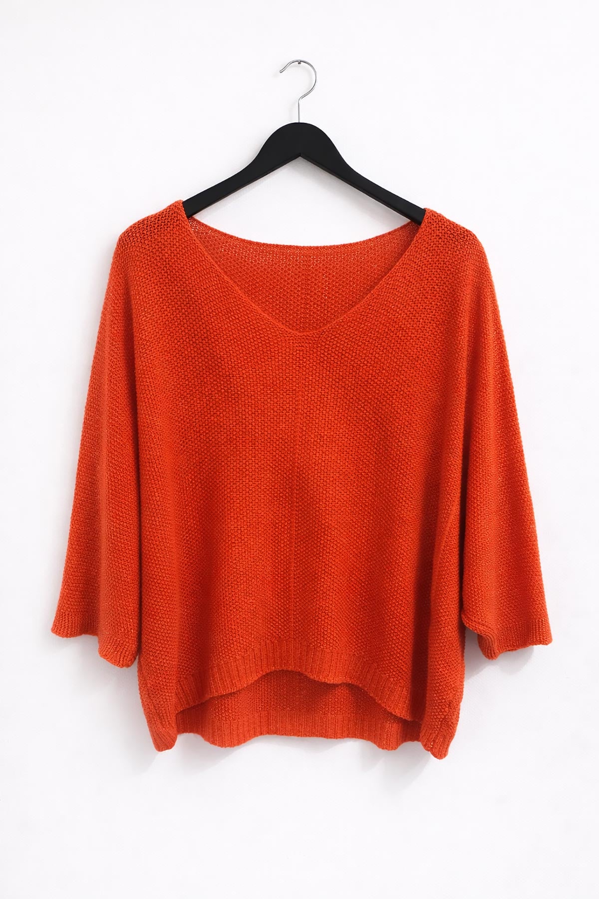 Close-up of Aurora knit top in orange showing lurex shimmer and soft knit texture