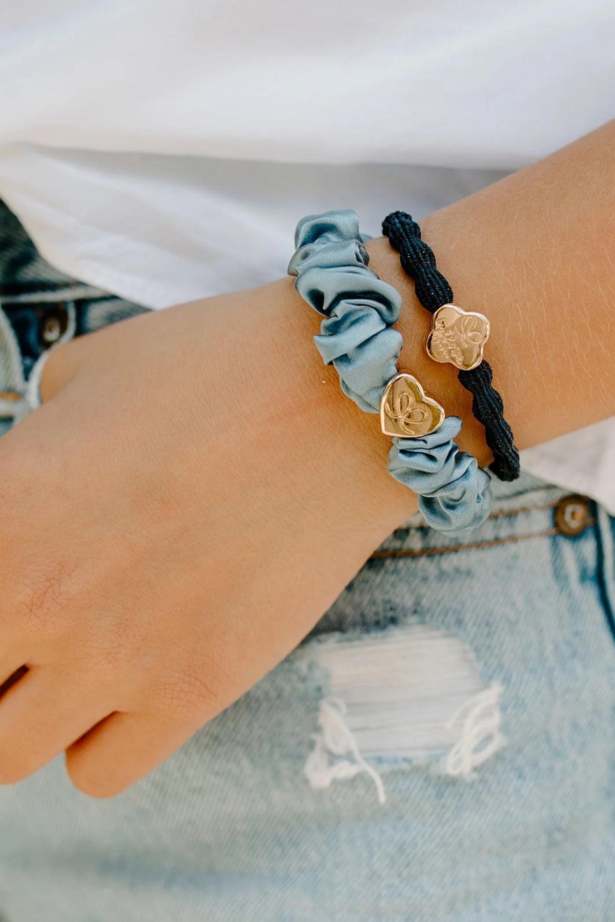 By Eloise faded denim scrunchie styled on the wrist