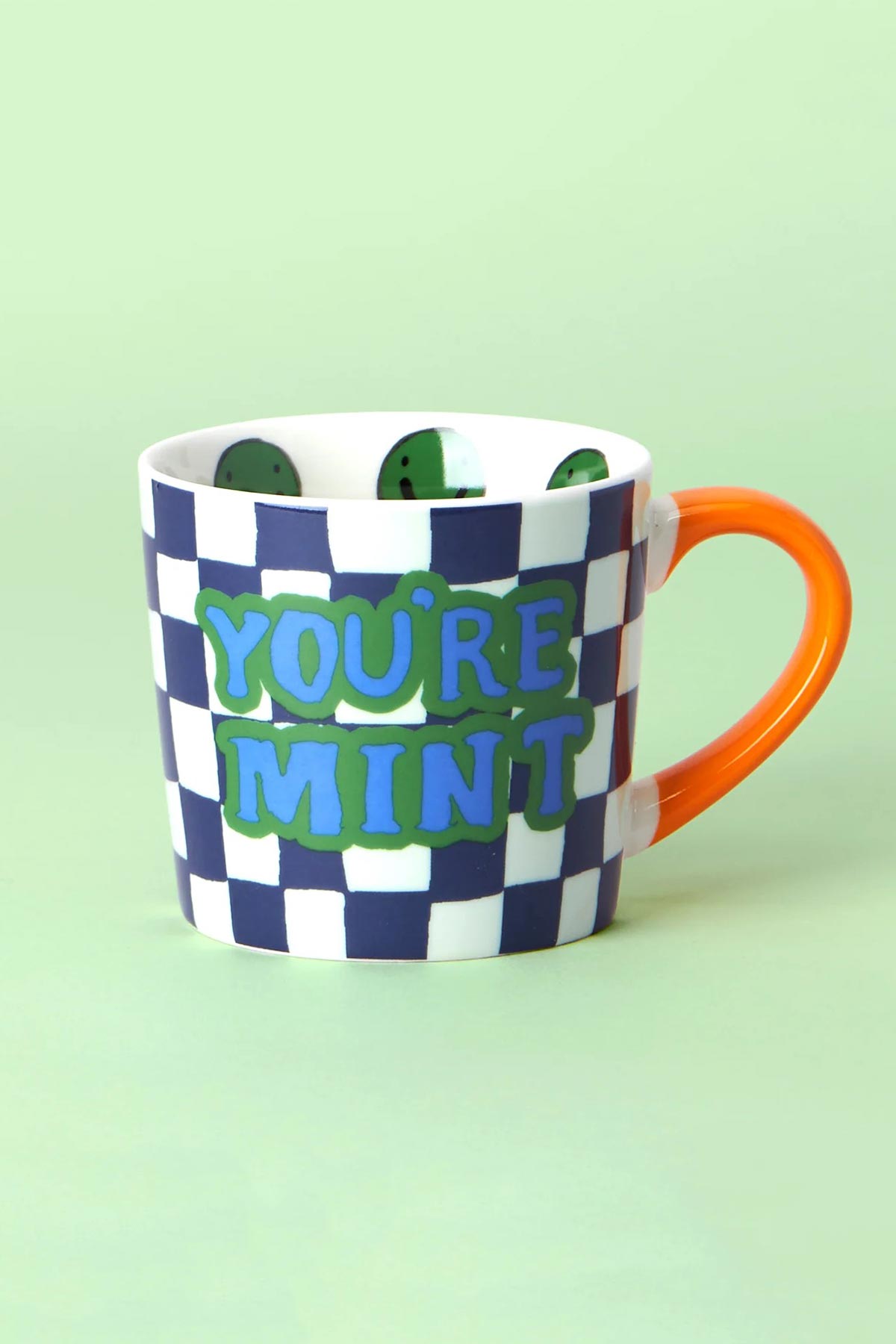 Detail of hand-painted checkerboard design on mug