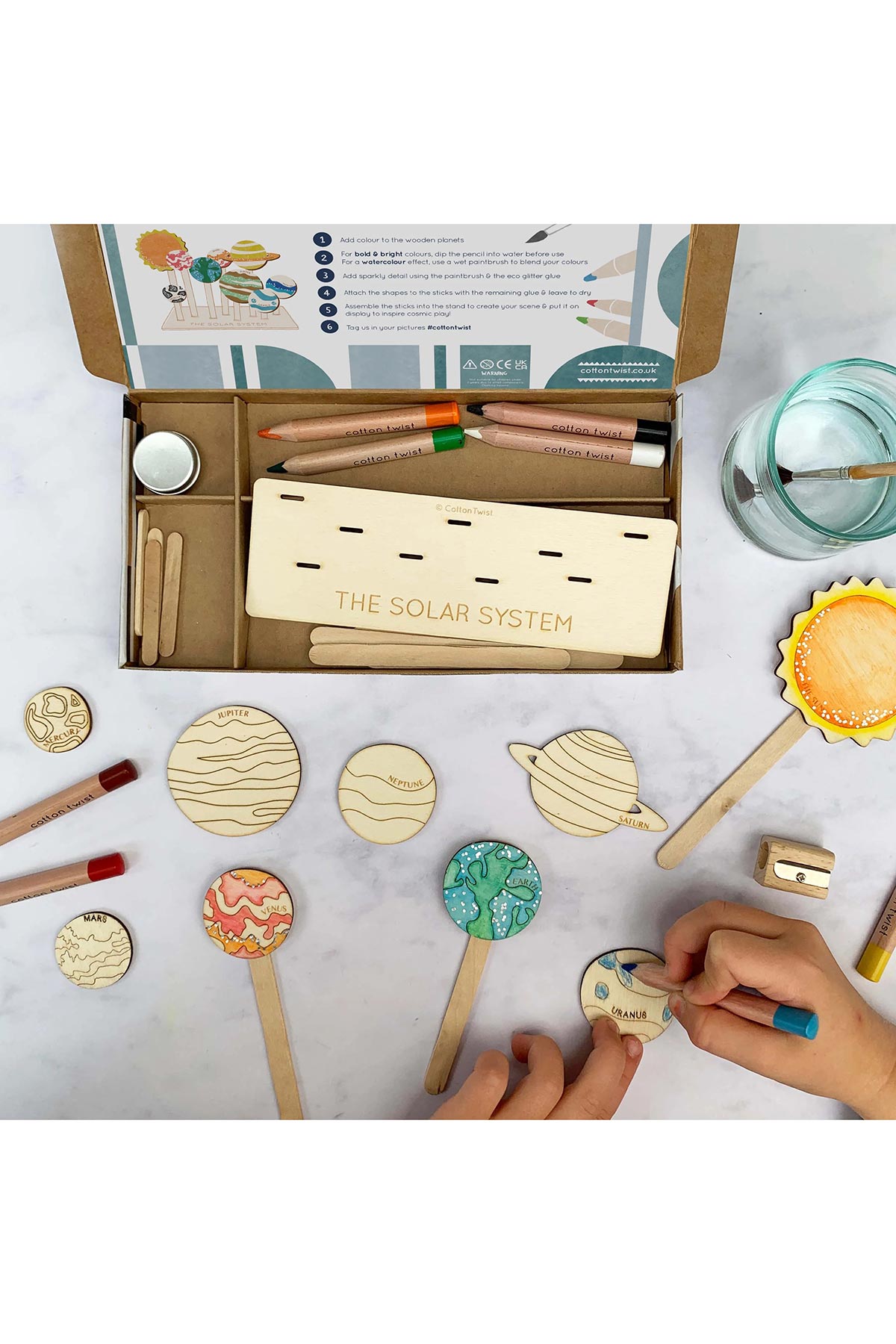 Child painting solar system