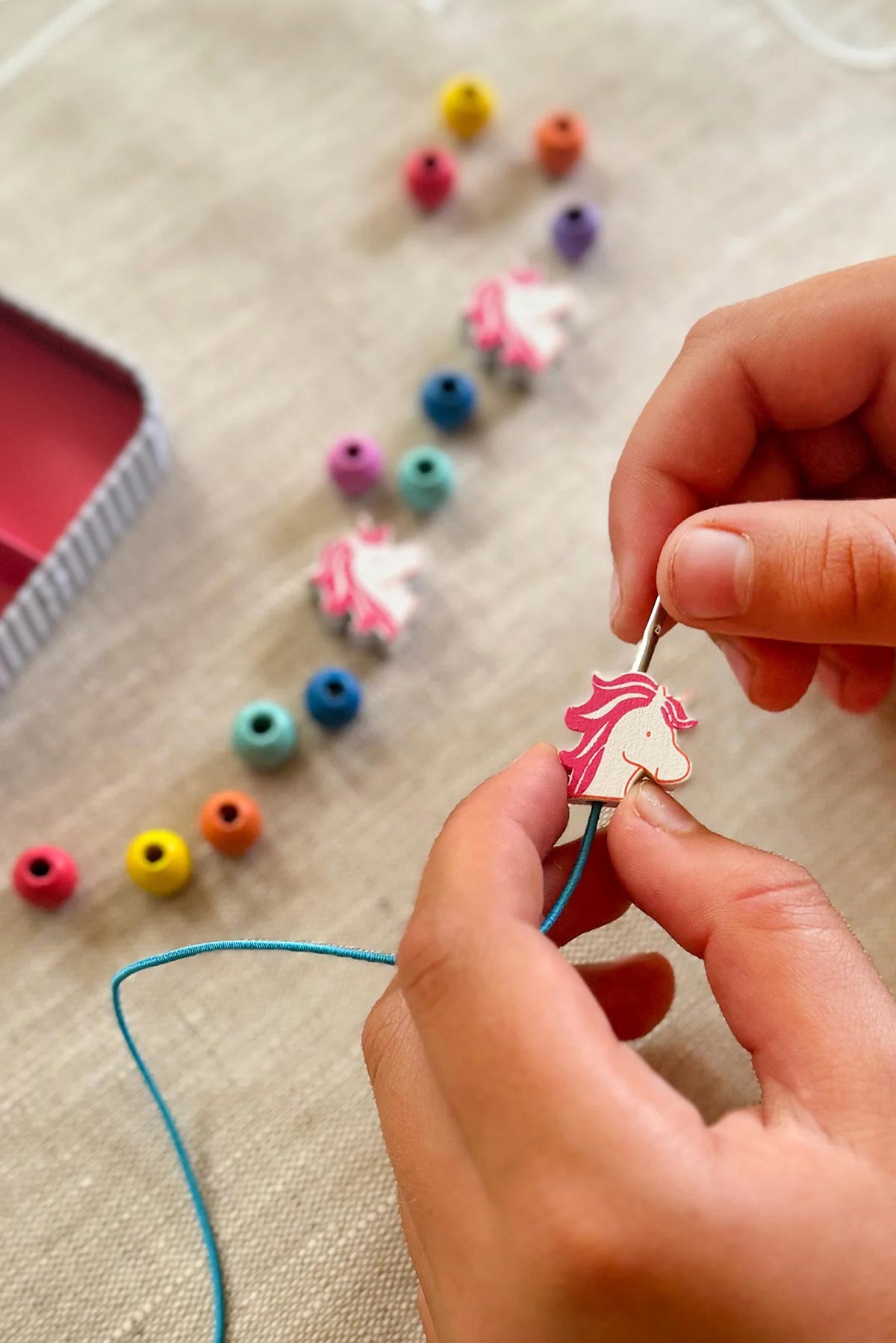 Child making unicorn bracelet