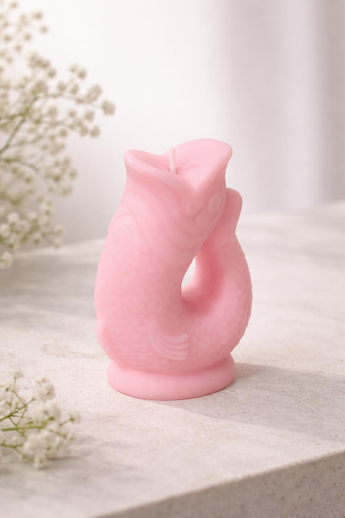 Side view of pink Gluggle Jug Candle with sculptural fish shape