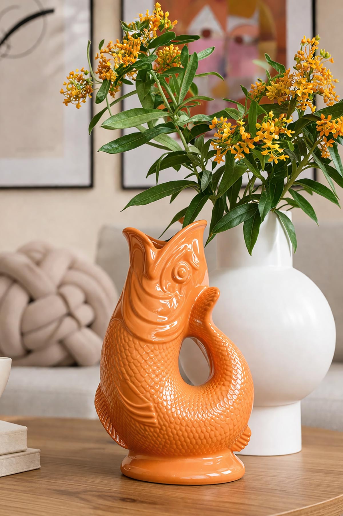 Orange Gluggle Jug styled as a decorative vase in a home setting