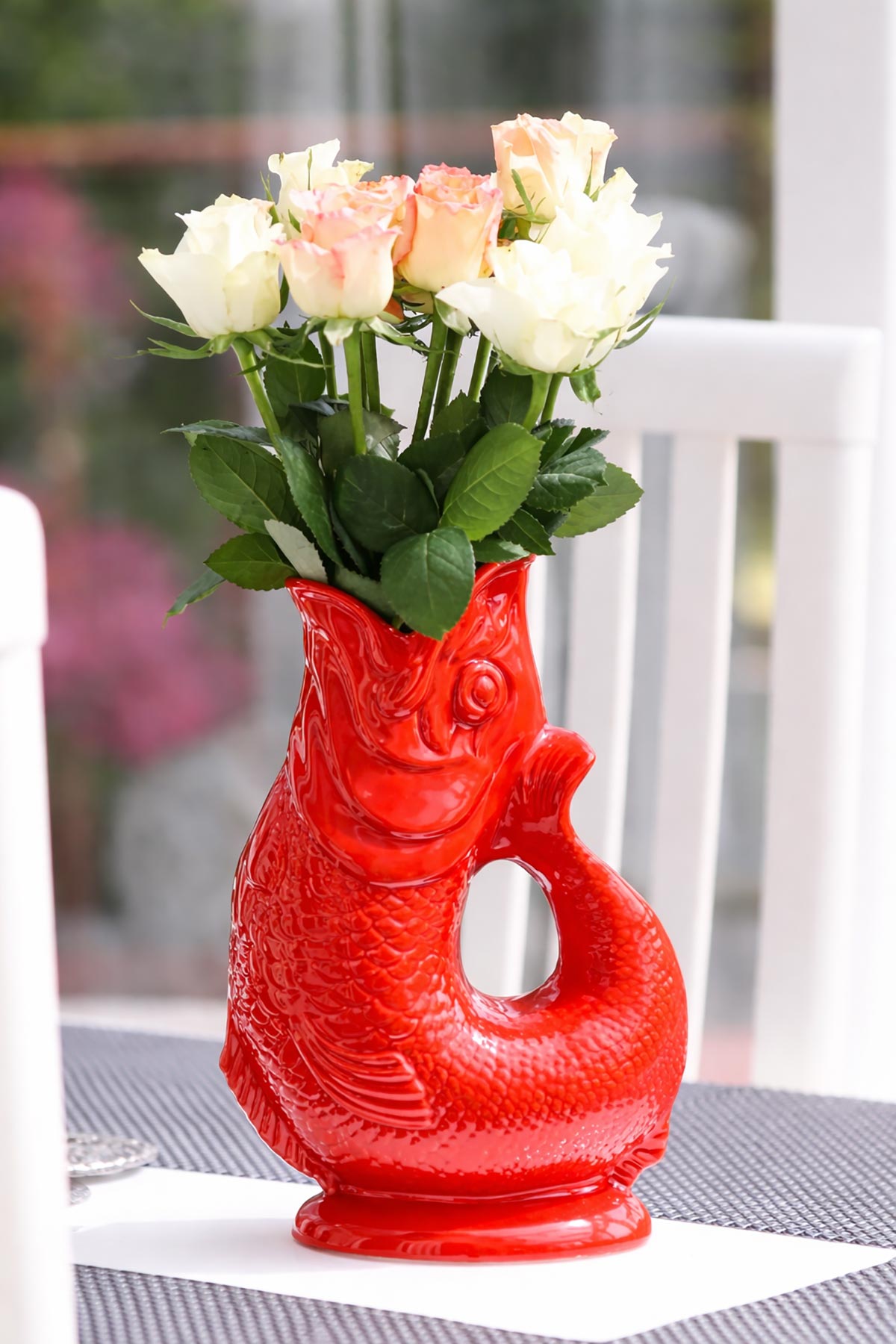 Red Gluggle Jug styled as a decorative vase in a home setting