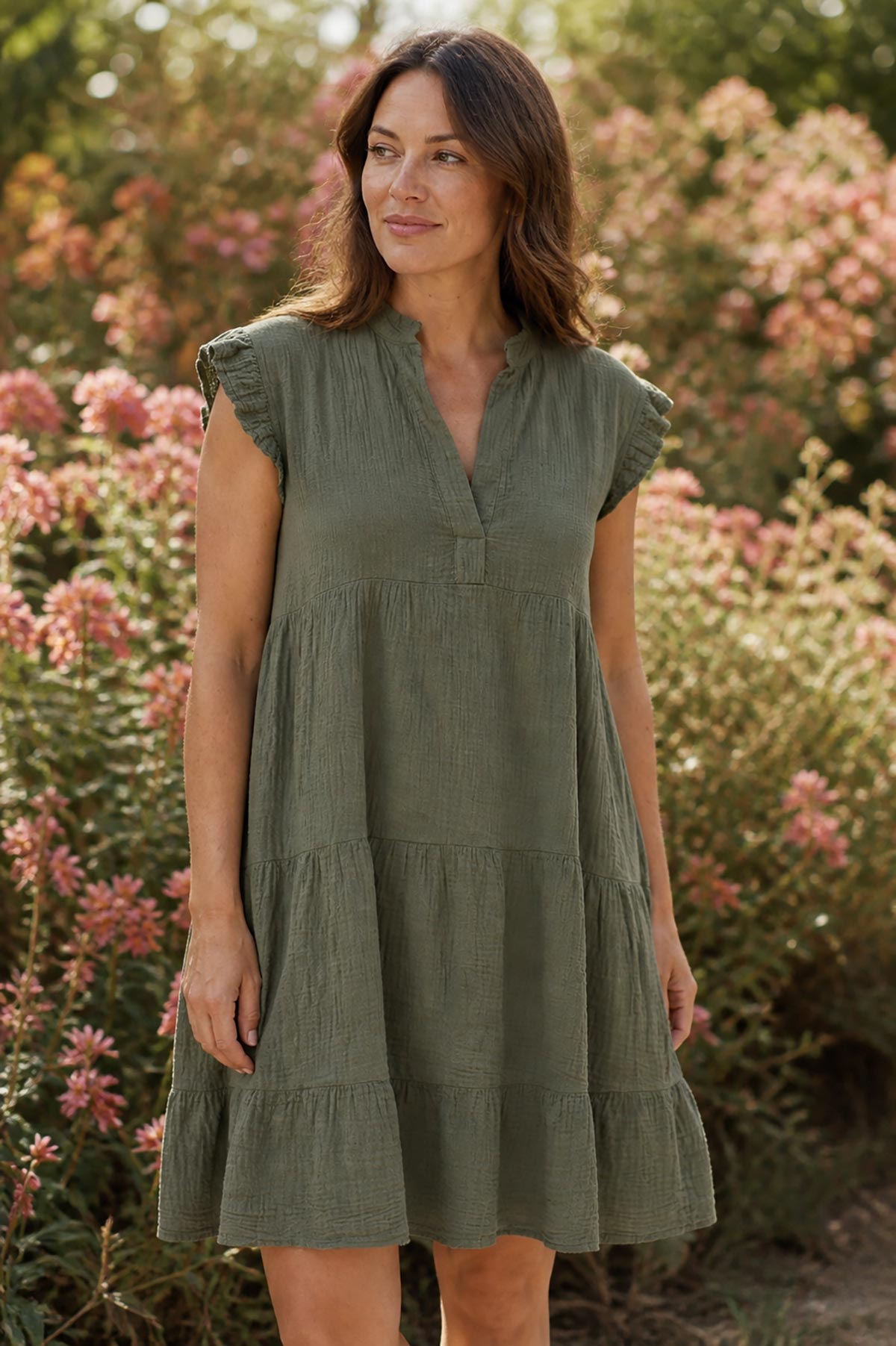Detail view of khaki cotton tiered dress with relaxed tiered silhouette and frill sleeves