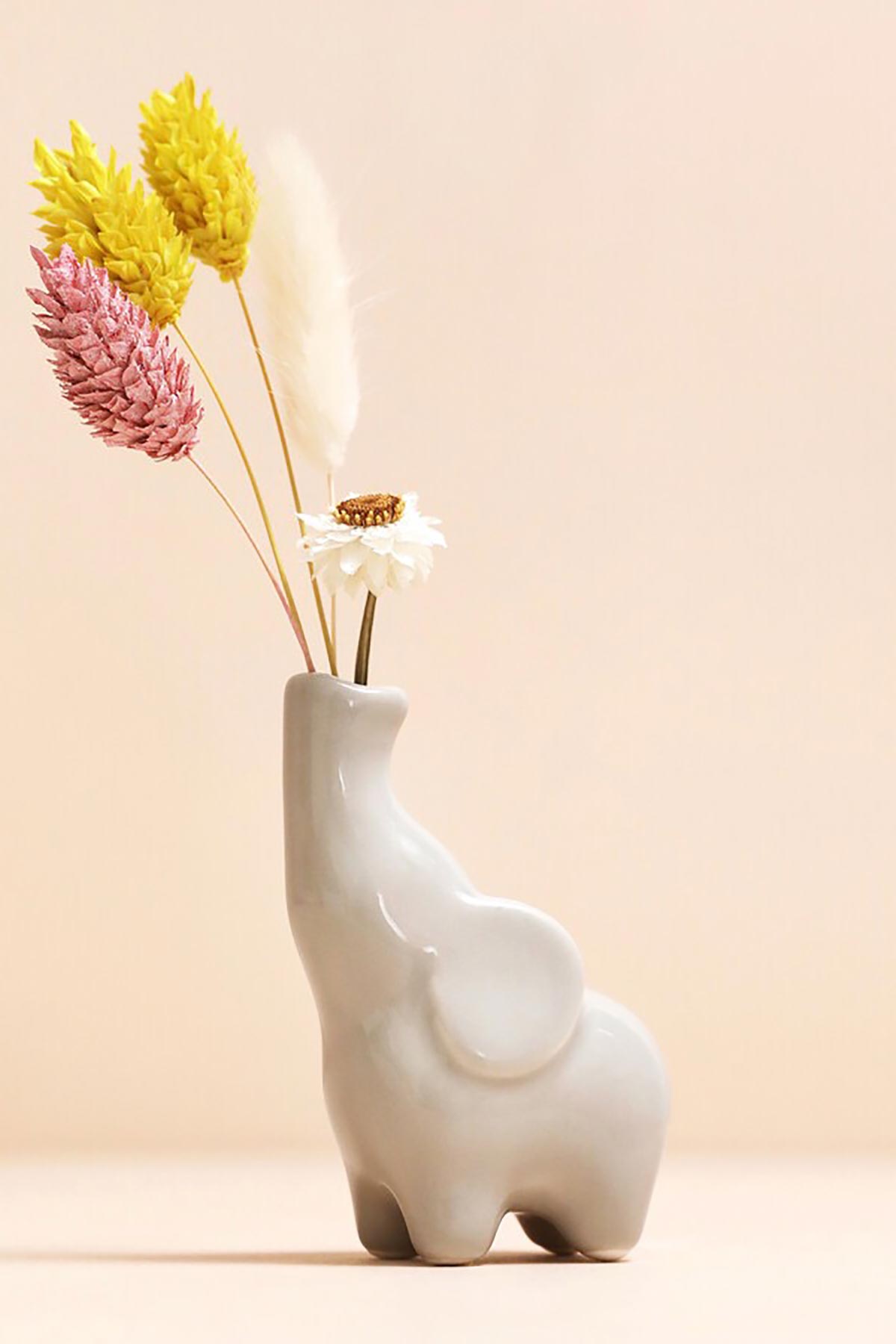 Elephant bud vase holding single stem
