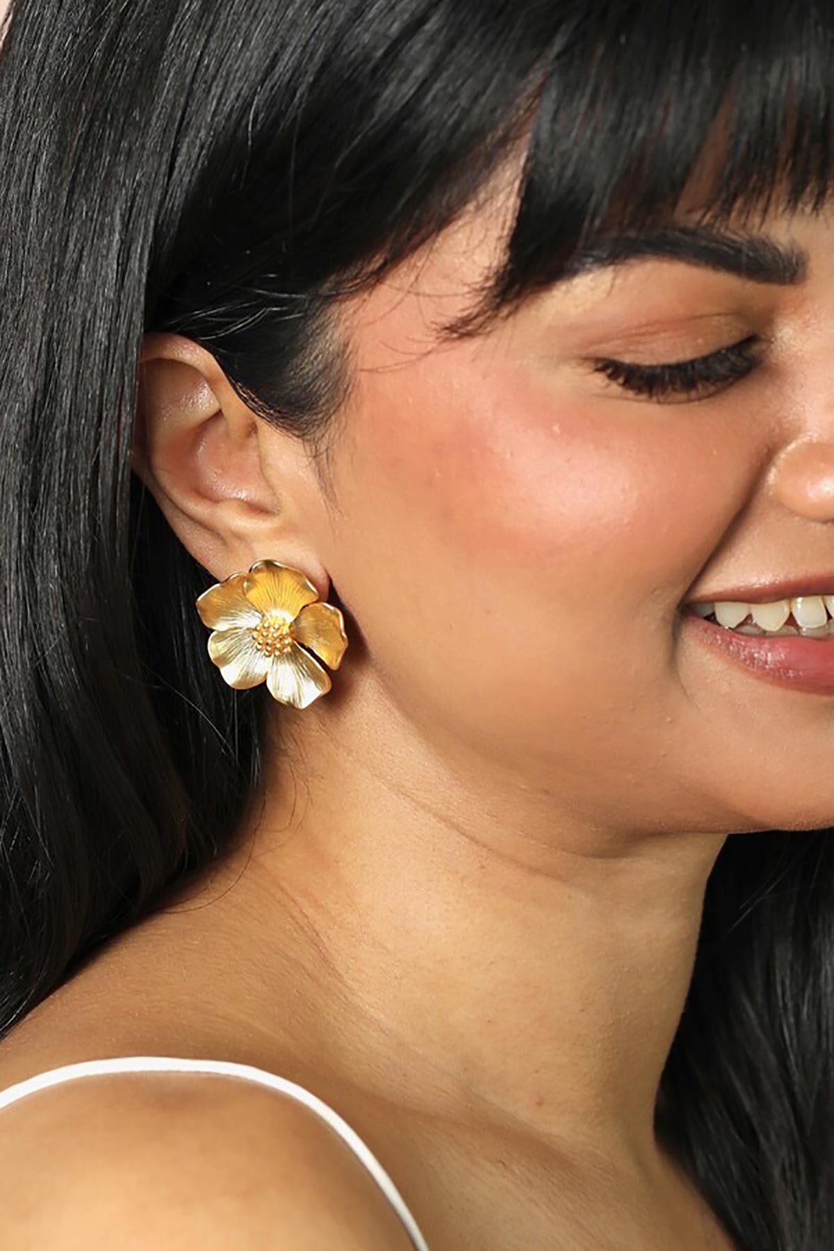 Flower stud earrings worn on ear