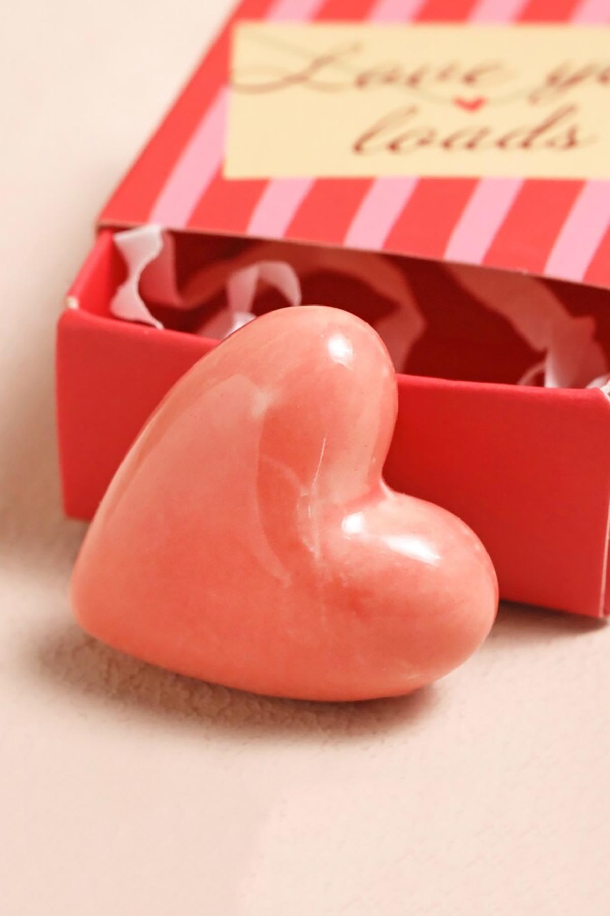 Ceramic heart token displayed outside matchbox