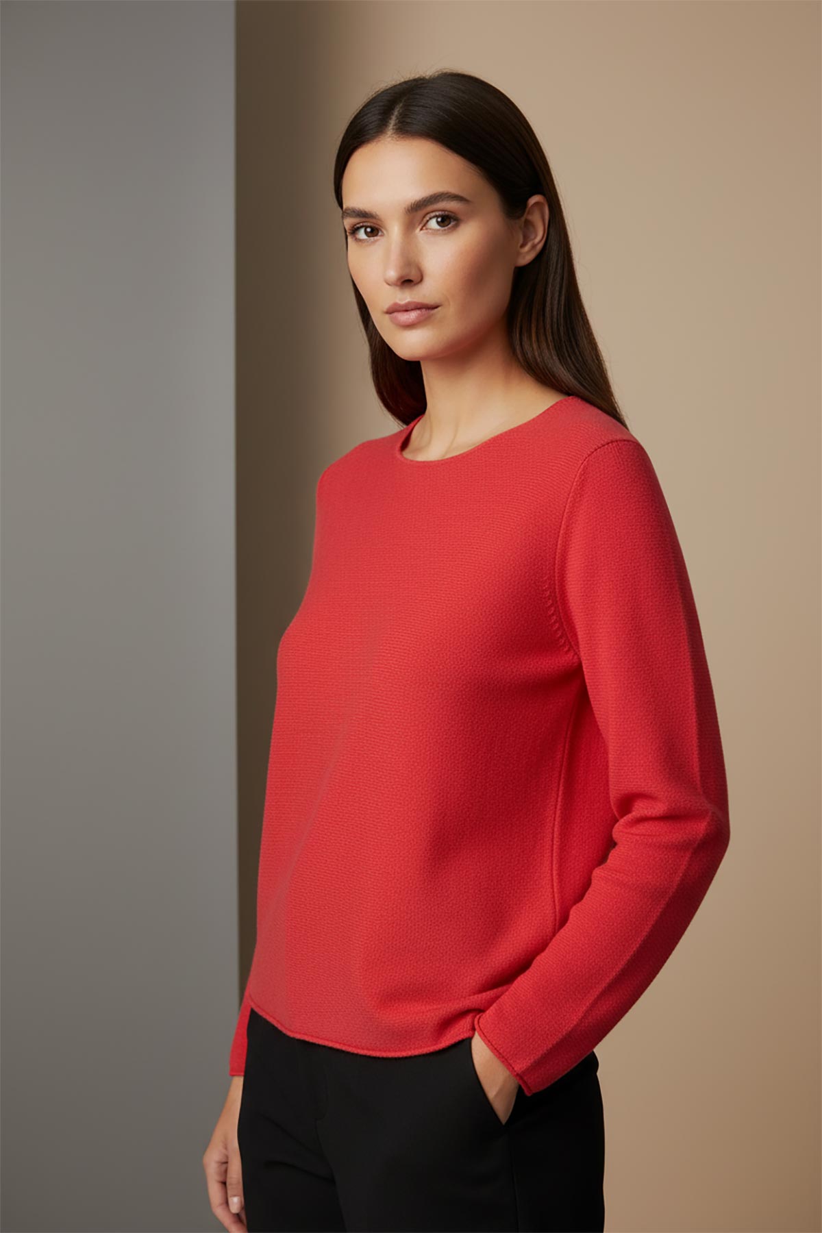 Model wearing coral red reversible seamless knit jumper made in Italy – elegant Italian knitwear by Urban Wild