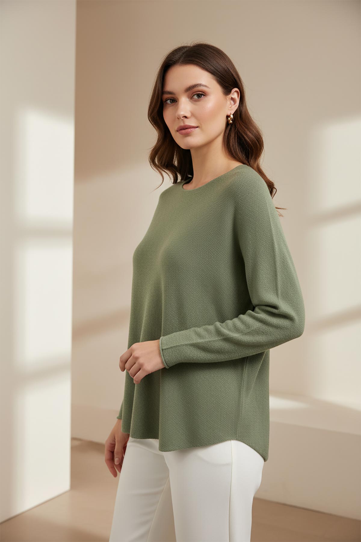 Model wearing sage green reversible seamless knit jumper made in Italy – elegant Italian knitwear by Urban Wild