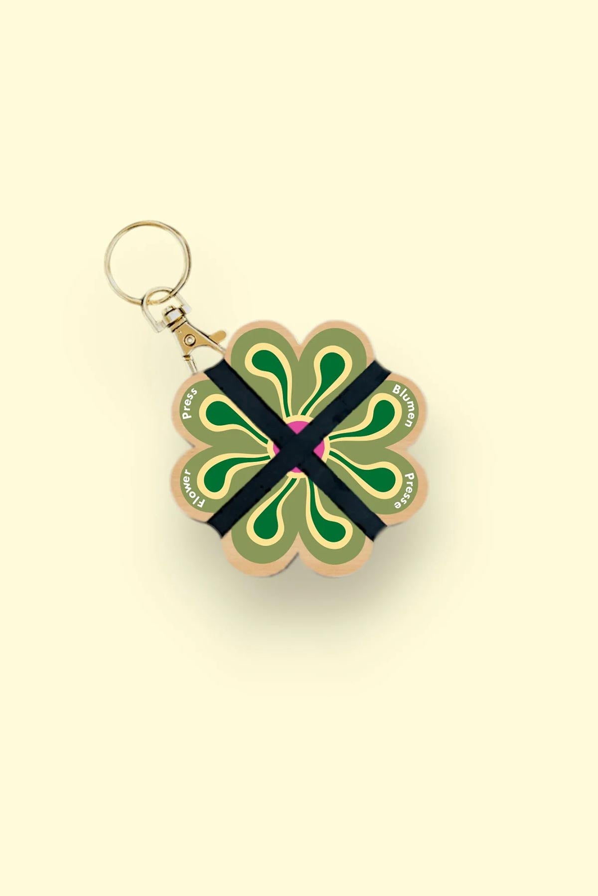 Nature lover using Studio Wald mini flower press outdoors keyring