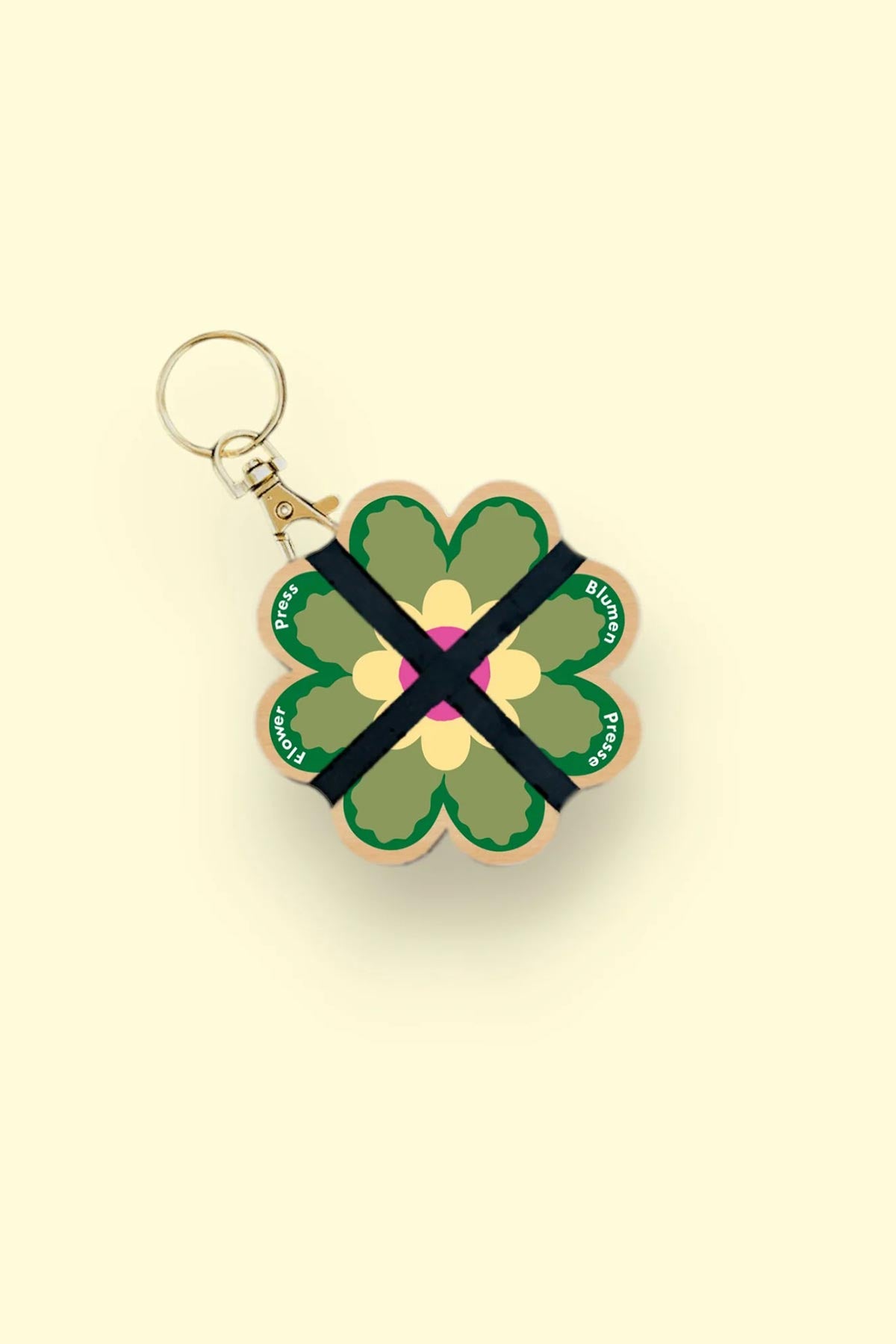 Nature lover using Studio Wald mini flower press outdoors keyring