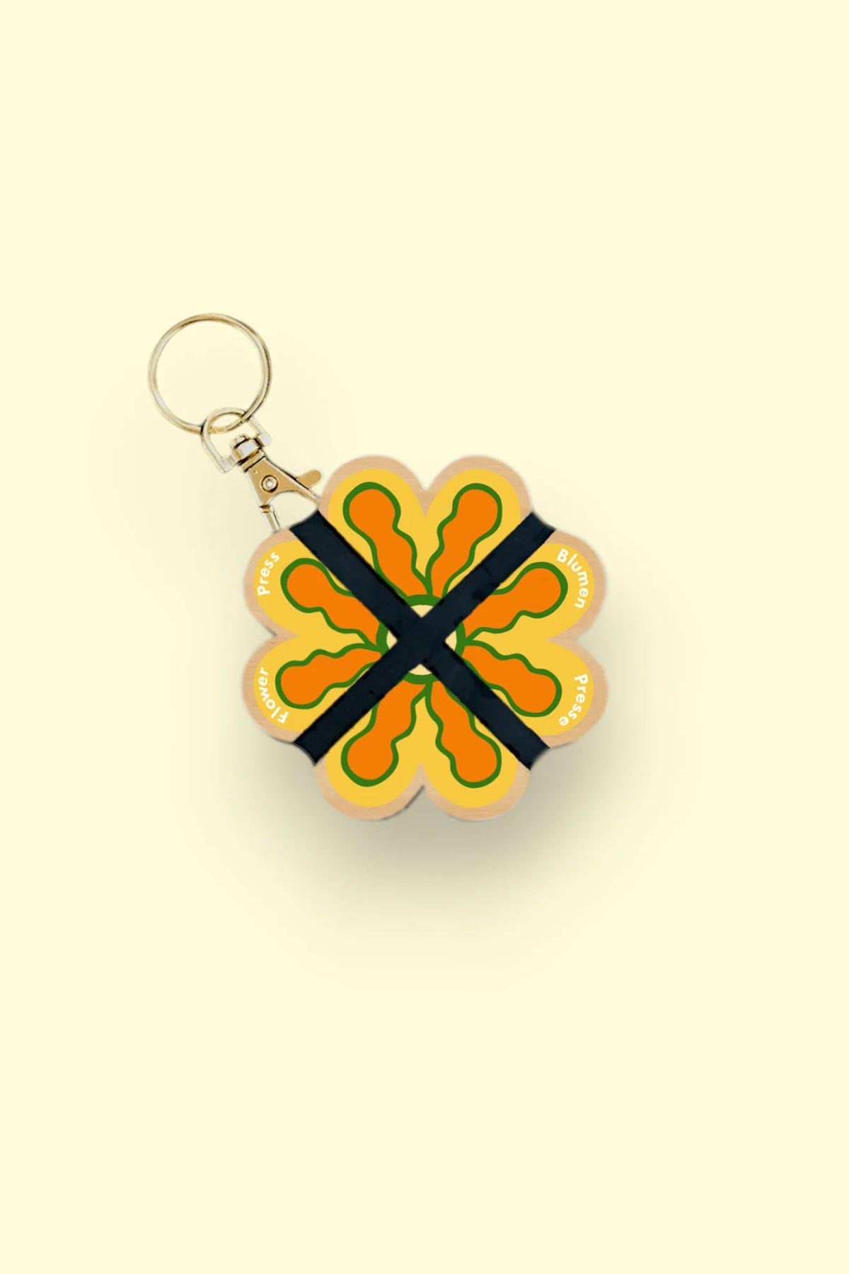 Nature lover using Studio Wald mini flower press outdoors keyring