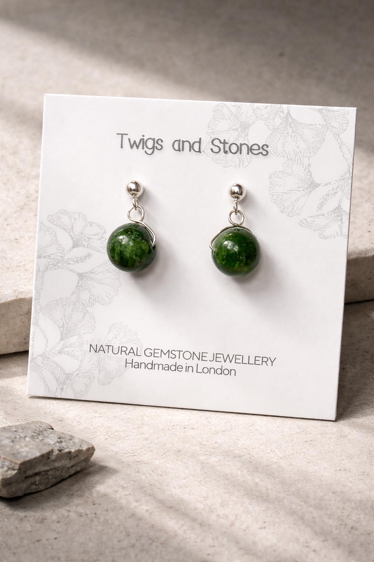 Close-up of green diopside gemstone stud earrings