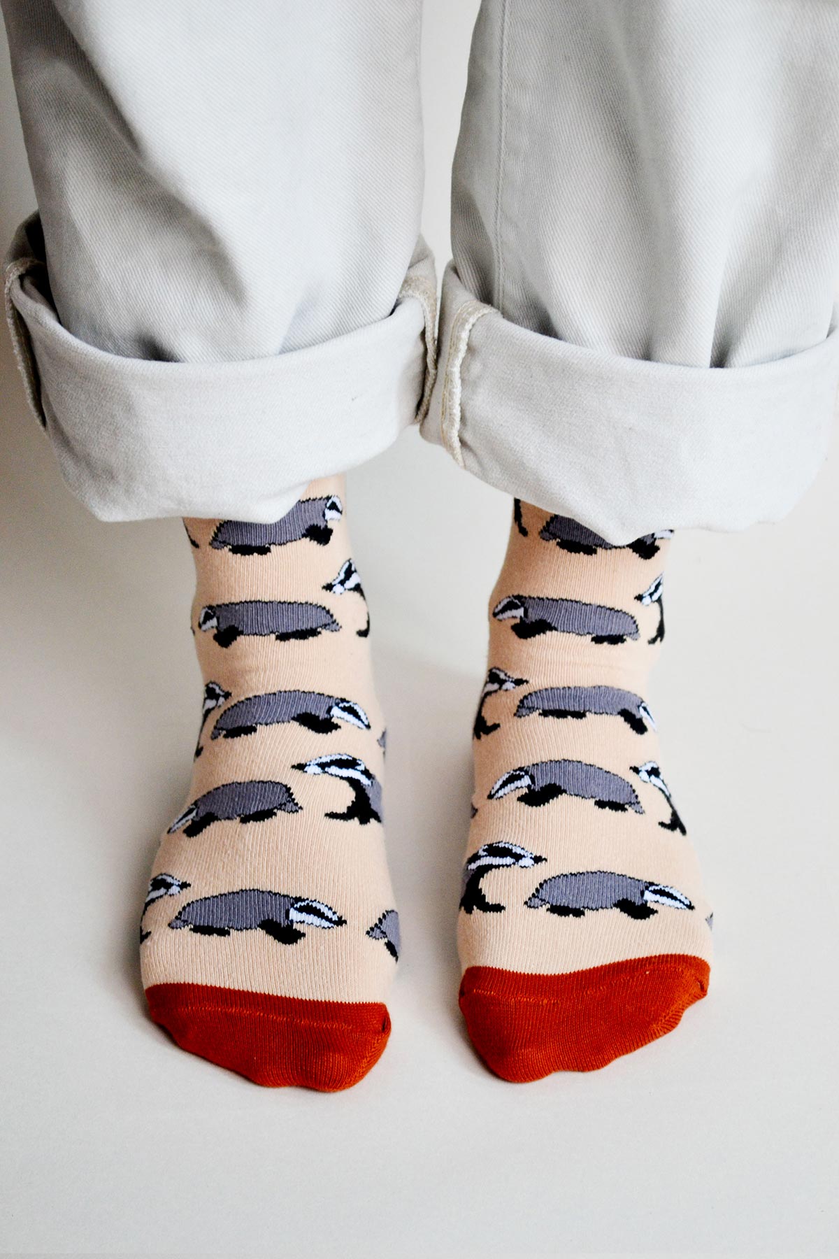 Beige badger bamboo crew socks worn with rolled cream trousers, front view — Urban Wild