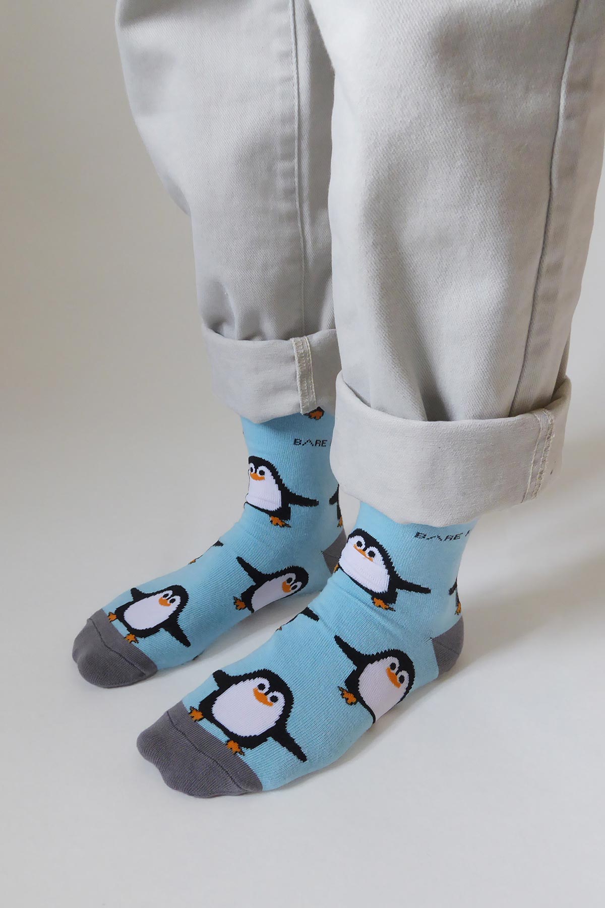 Blue bamboo crew socks with penguin print worn with cream turn up jeans Urban Wild