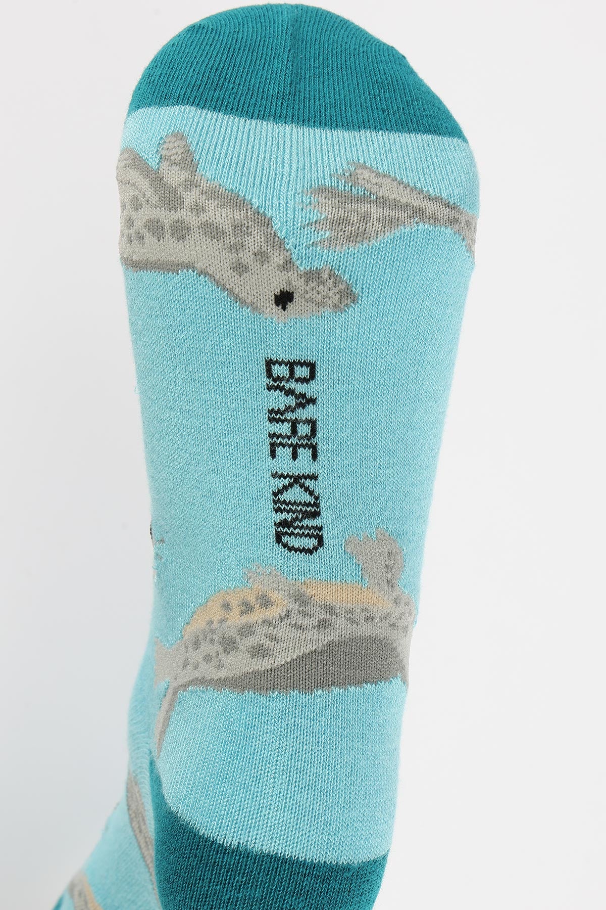 Blue bamboo crew sock close-up showing seal motif and Bare Kind logo detail — Urban Wild