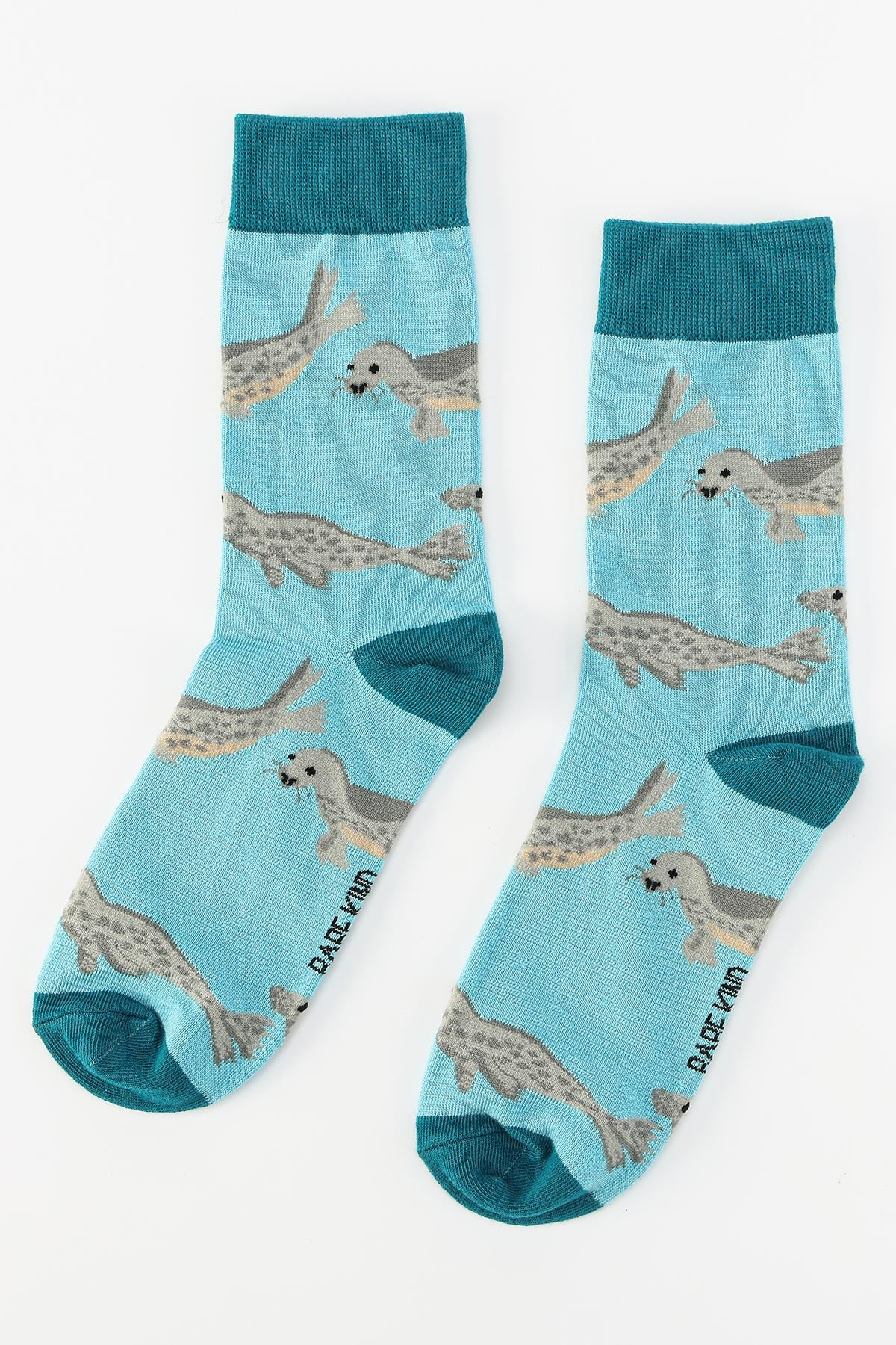 Pair of blue bamboo crew socks with all over seal pattern flat lay — Urban Wild