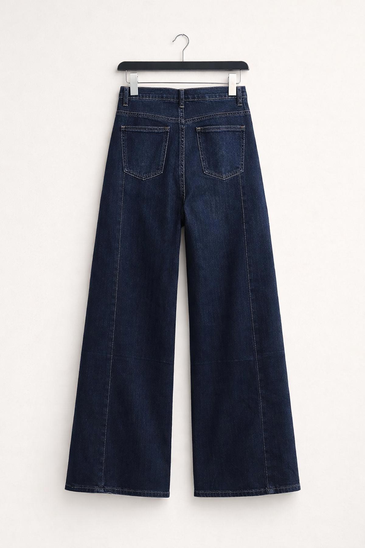 Detail of panelled seam design on indigo denim