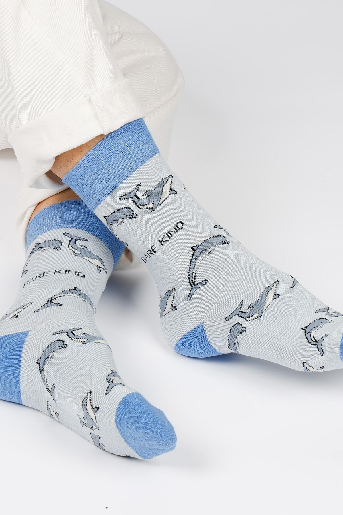 Blue dolphin print bamboo crew socks worn with cream trousers, soft and breathable — Urban Wild