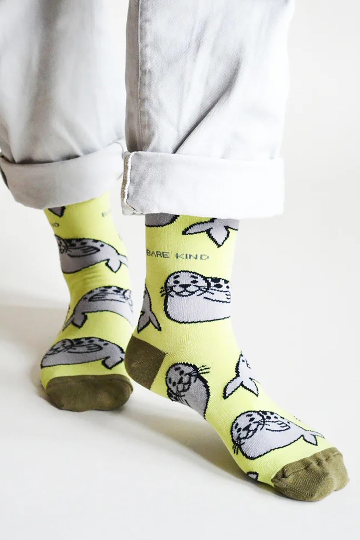 Green bamboo crew socks with grey seal print worn with rolled white jeans — Urban Wild