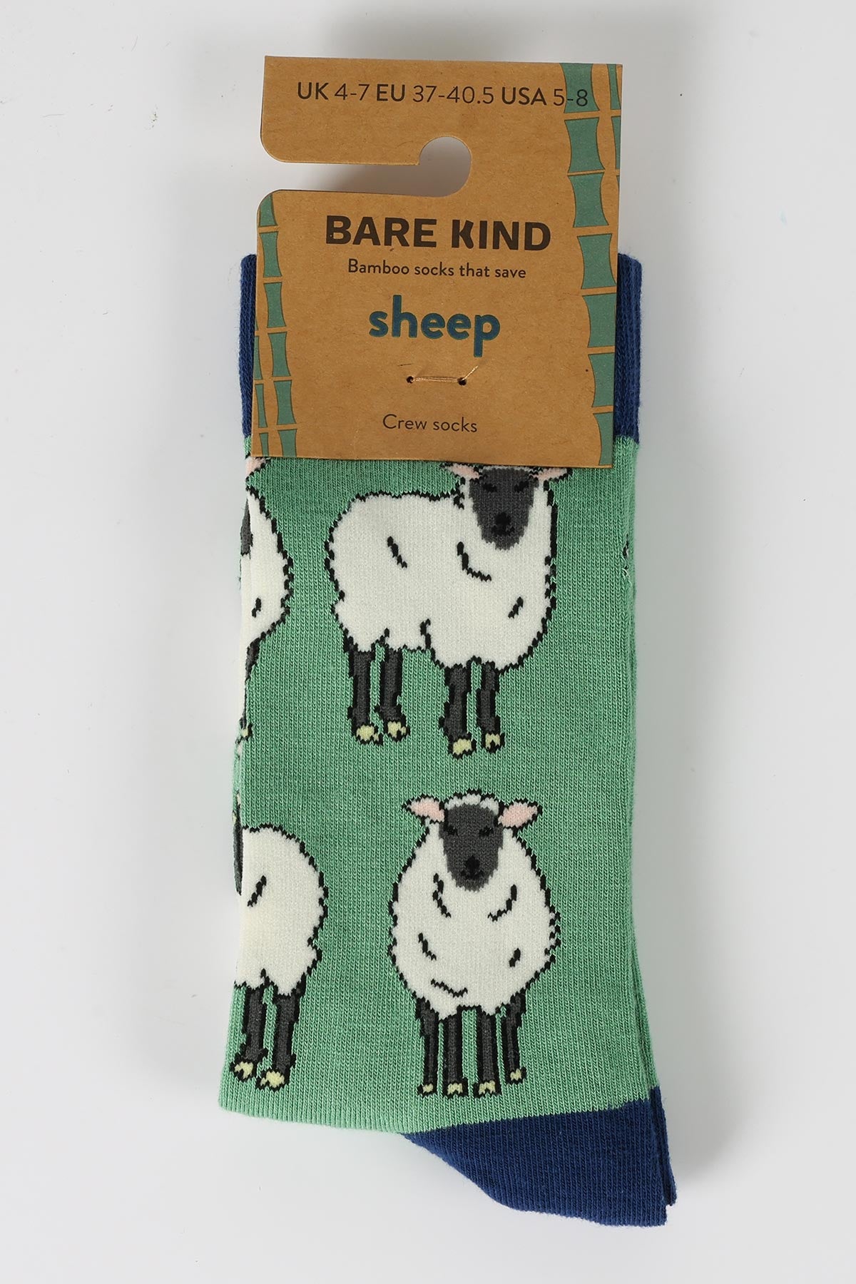 Green bamboo crew socks with white sheep design in Bare Kind recyclable packaging - Urban Wild