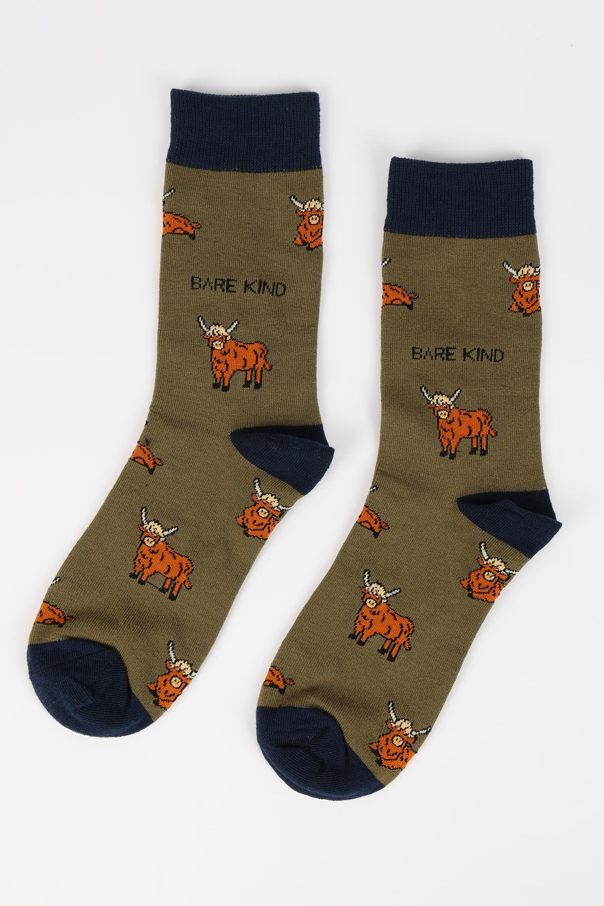 Pair of khaki green bamboo crew socks featuring orange Highland cows and navy heel and toe — Urban Wild