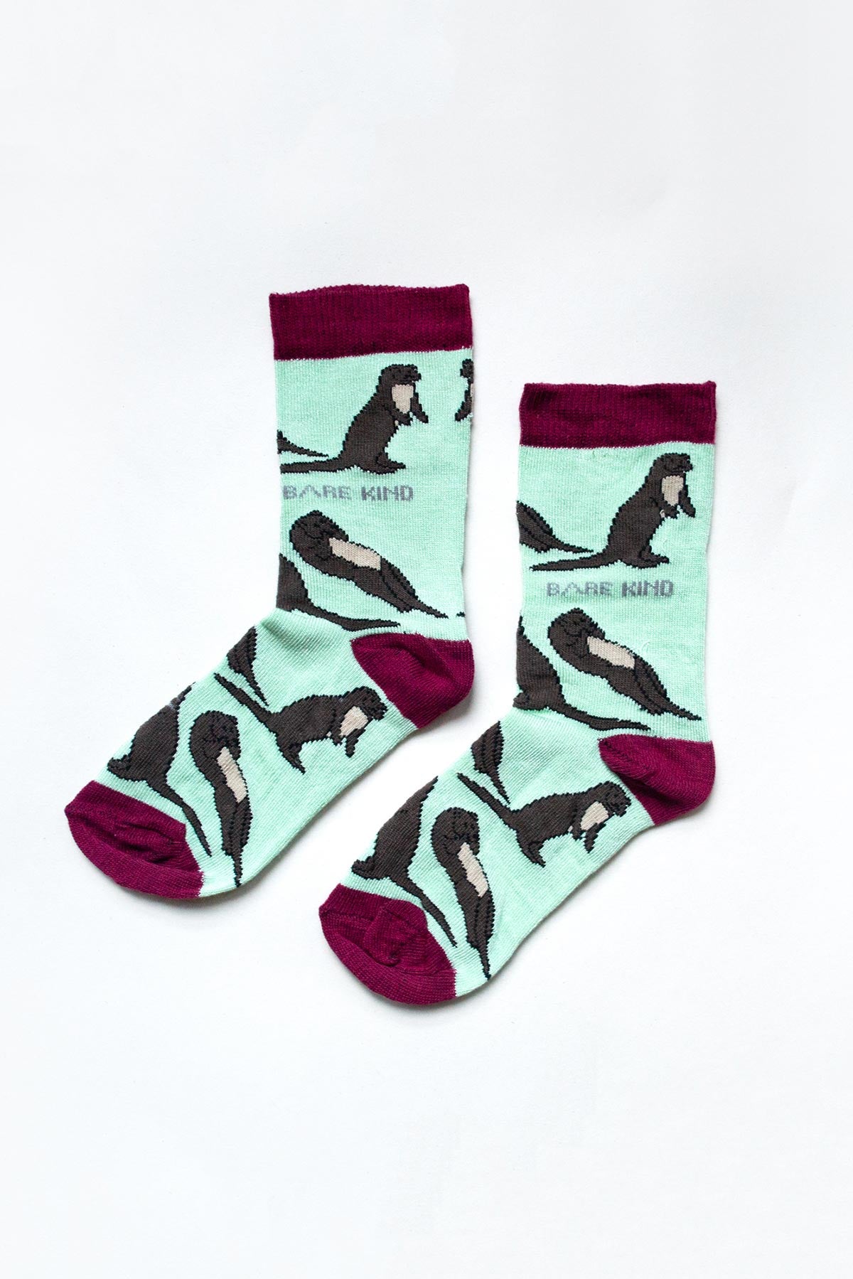 Pair of mint green and burgundy otter bamboo socks for kids by Bare Kind — Urban Wild