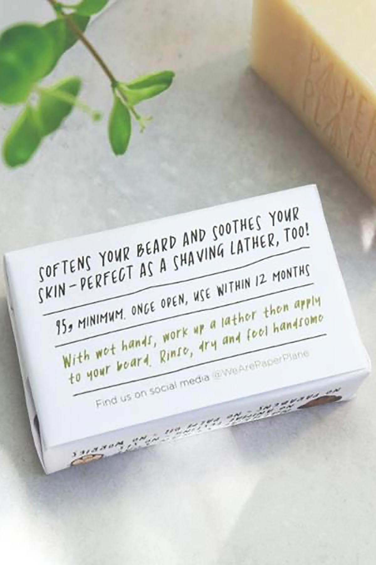 Reverse of Paper Plane natural beard shampoo bar showing usage and ingredients — Urban Wild