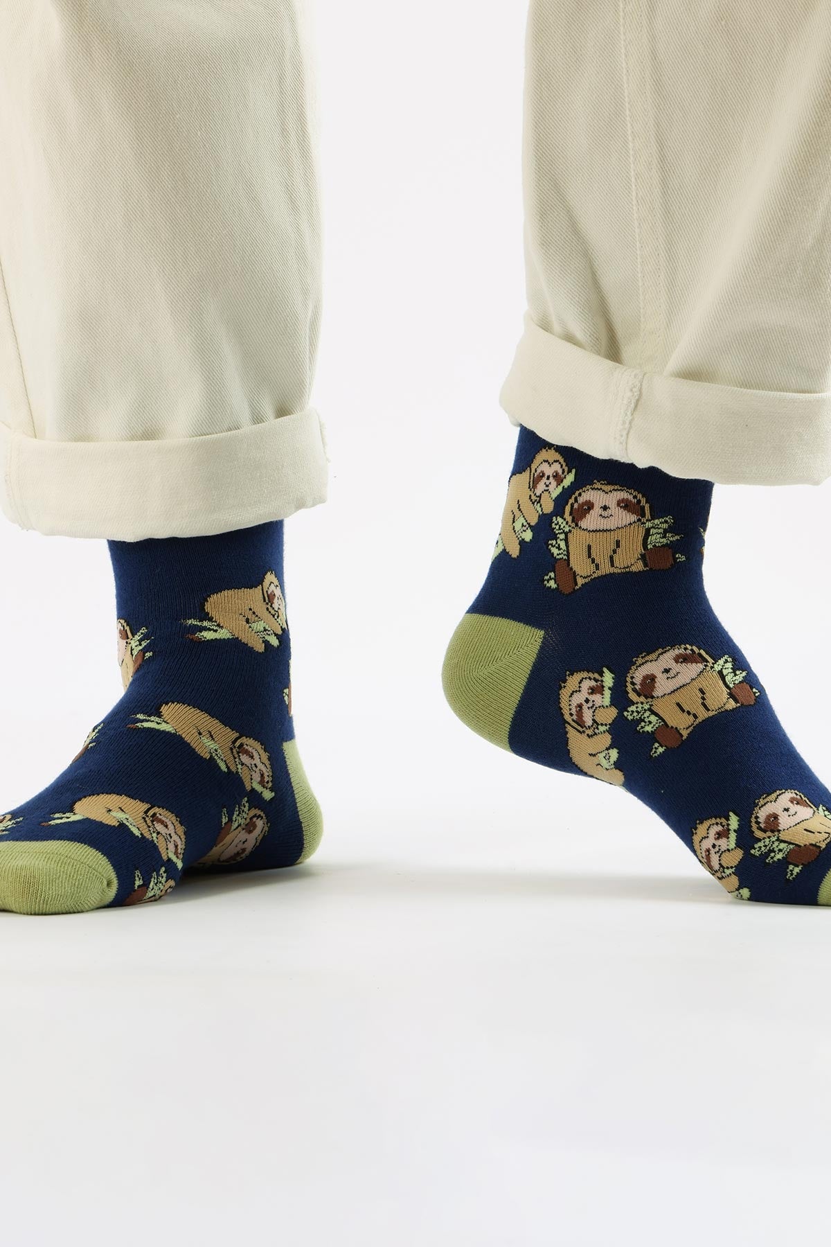 Navy bamboo sloth crew socks with green cuff worn with cream trousers — Urban Wild