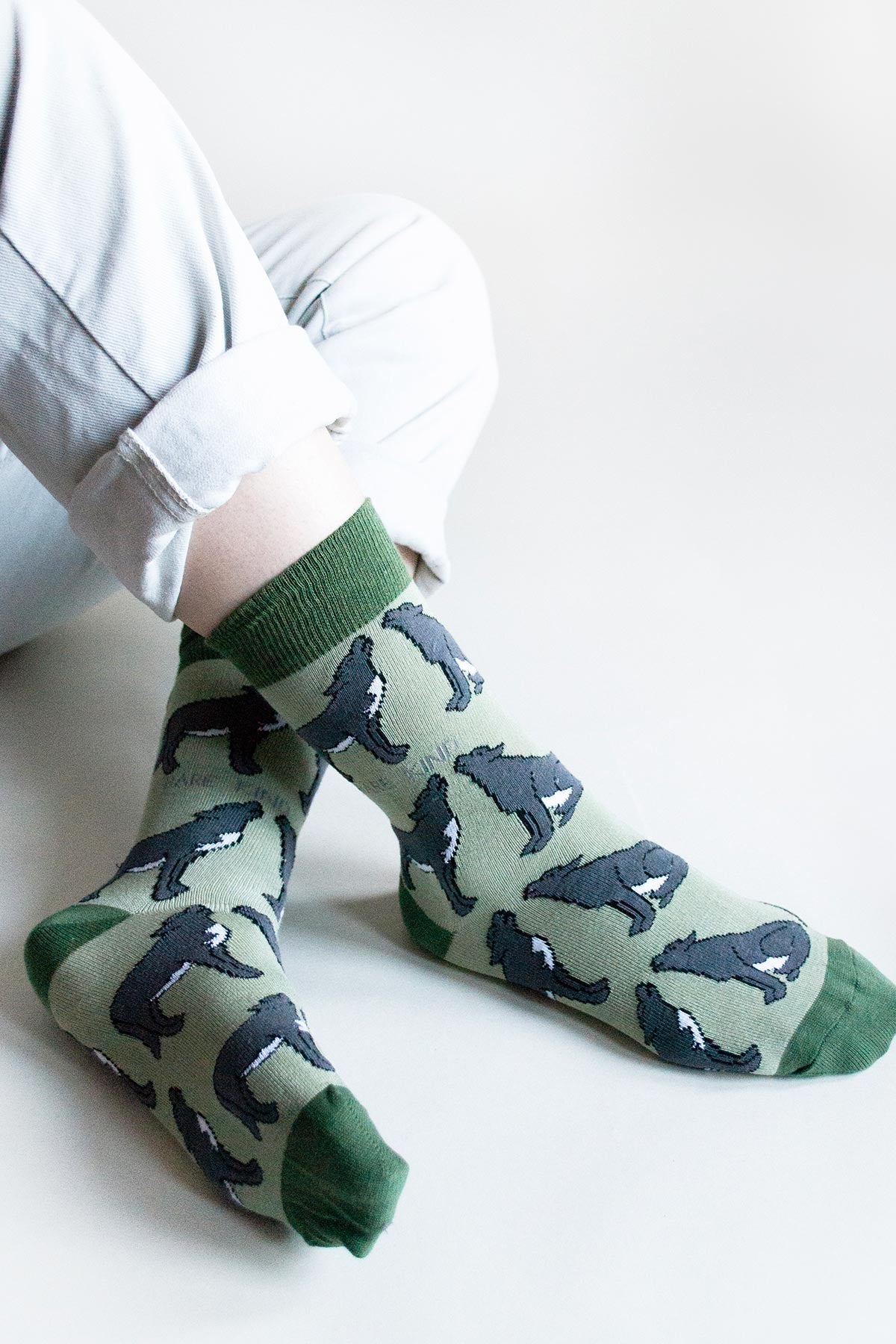 Model wearing sage green bamboo wolf crew socks with cream trousers — Urban Wild