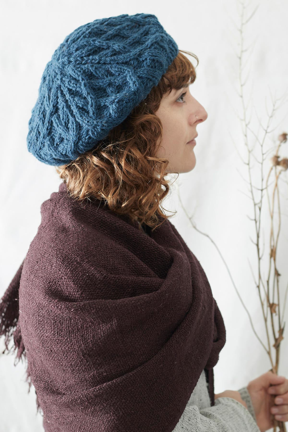 Model wearing Aura Que Bibek scarf in plum purple