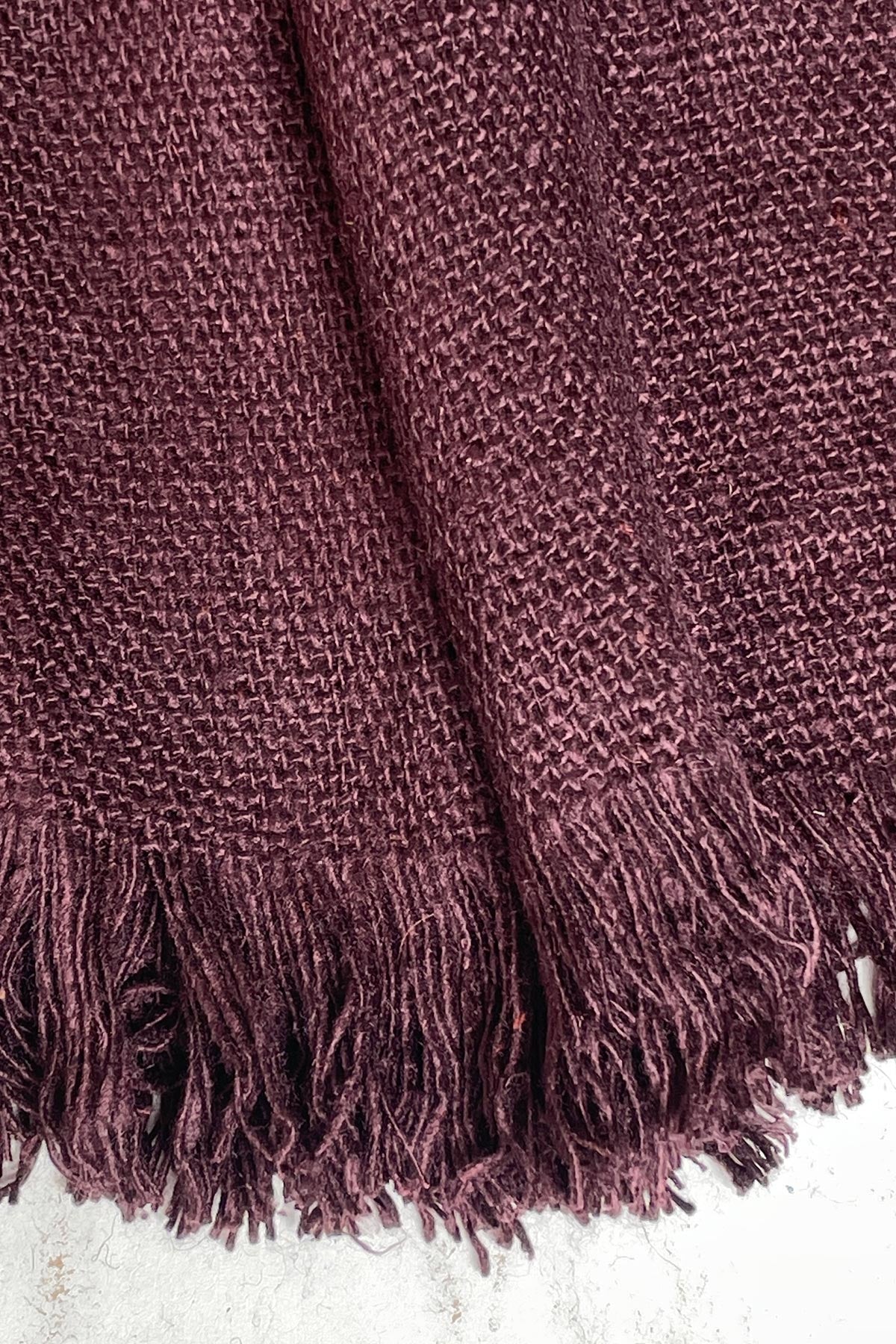 Close-up texture of Bibek banana fibre scarf in plum purple