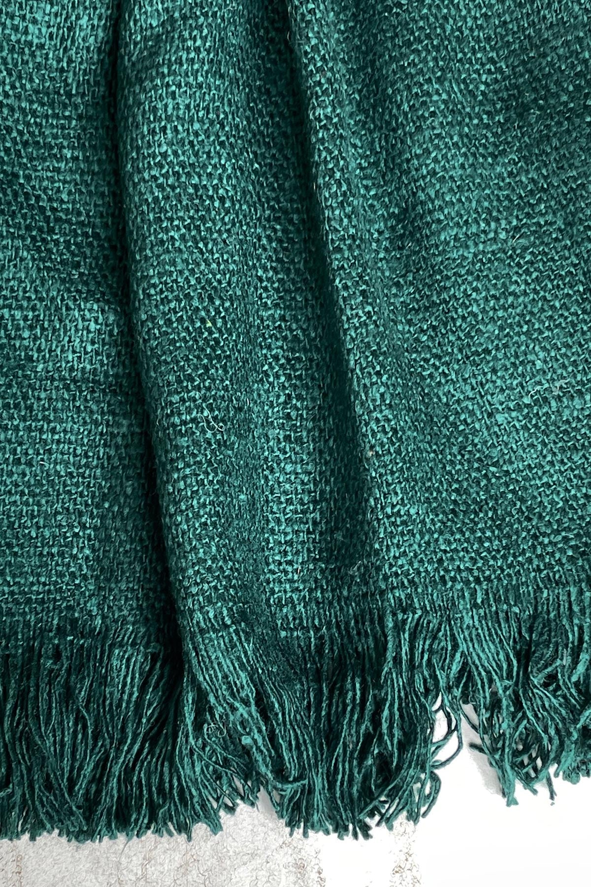 Close-up texture of Bibek banana fibre scarf in teal green