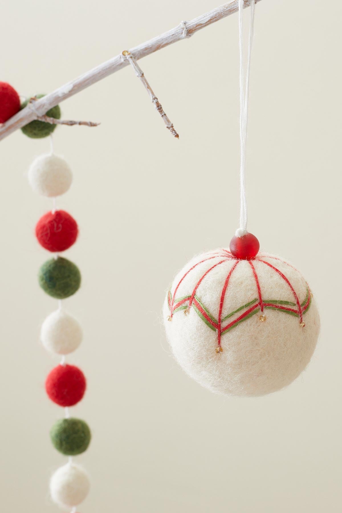 Hanging felt bauble in cream
