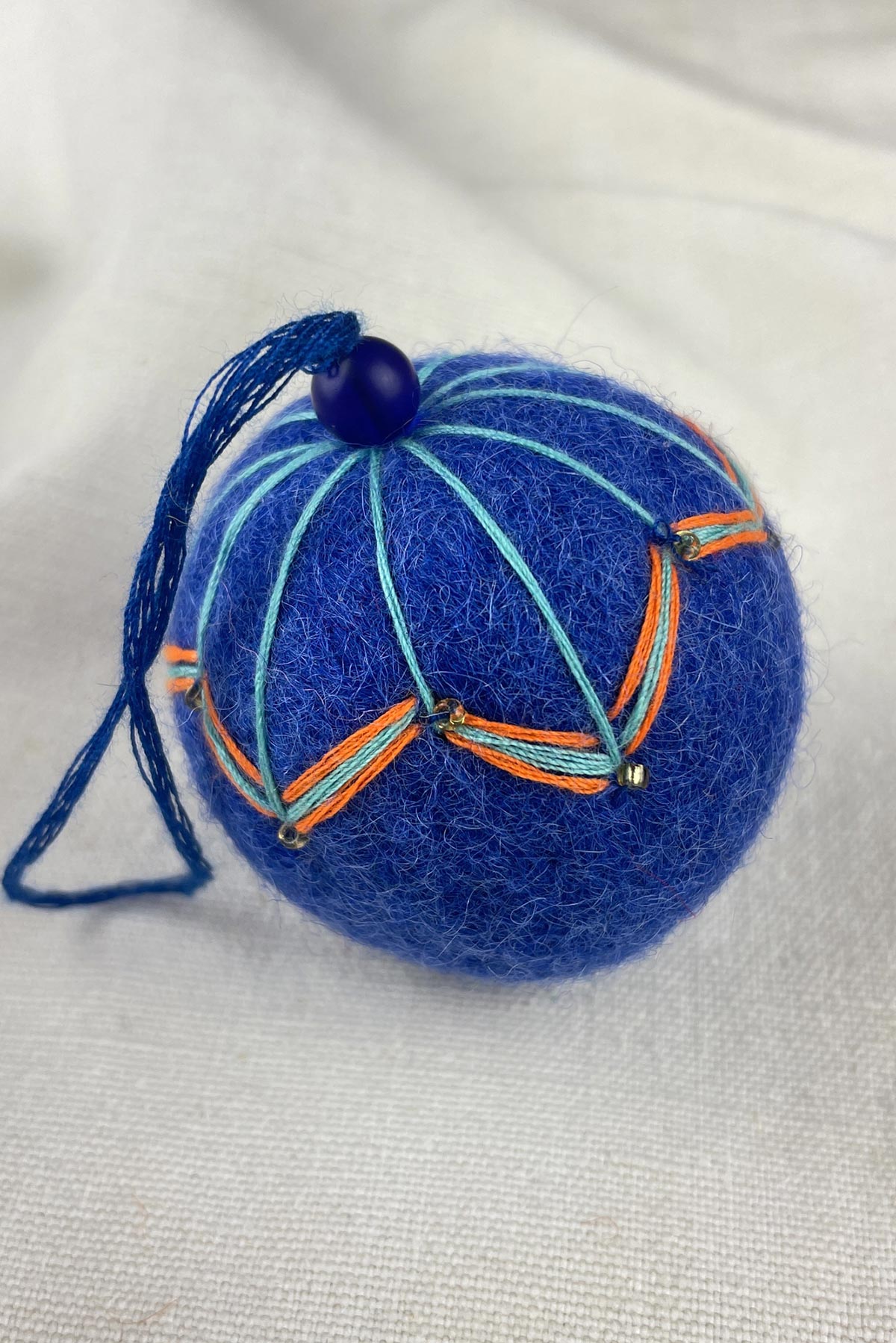 Close-up of beads on felt bauble in moroccan blue