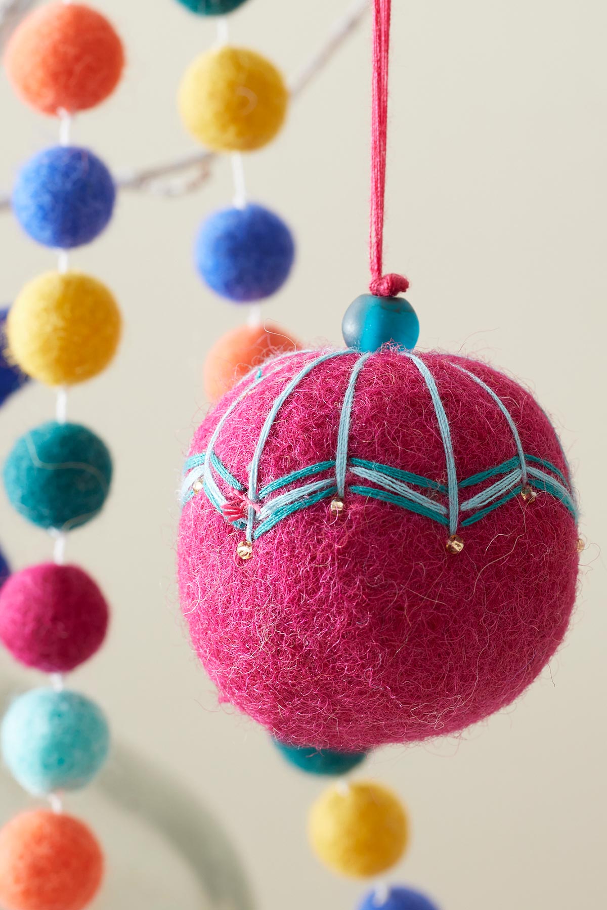 Hanging felt bauble in raspberry pink