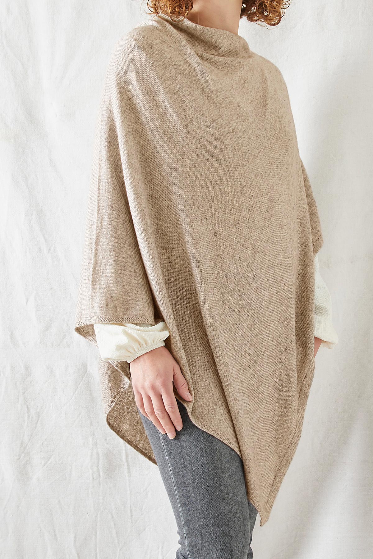Model wearing Risi merino poncho in desert beige