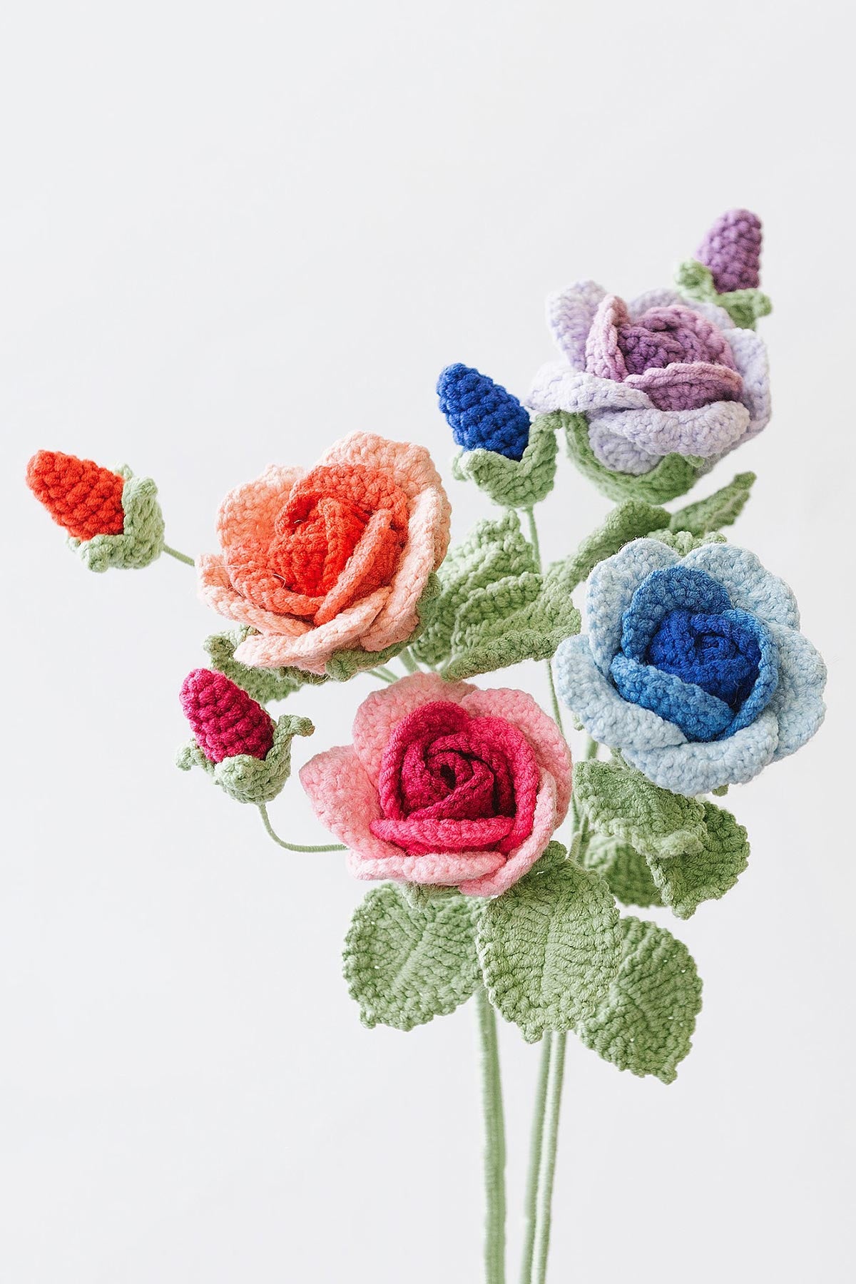 Close-up of handmade crochet baby rose showing layered texture and delicate craftsmanship