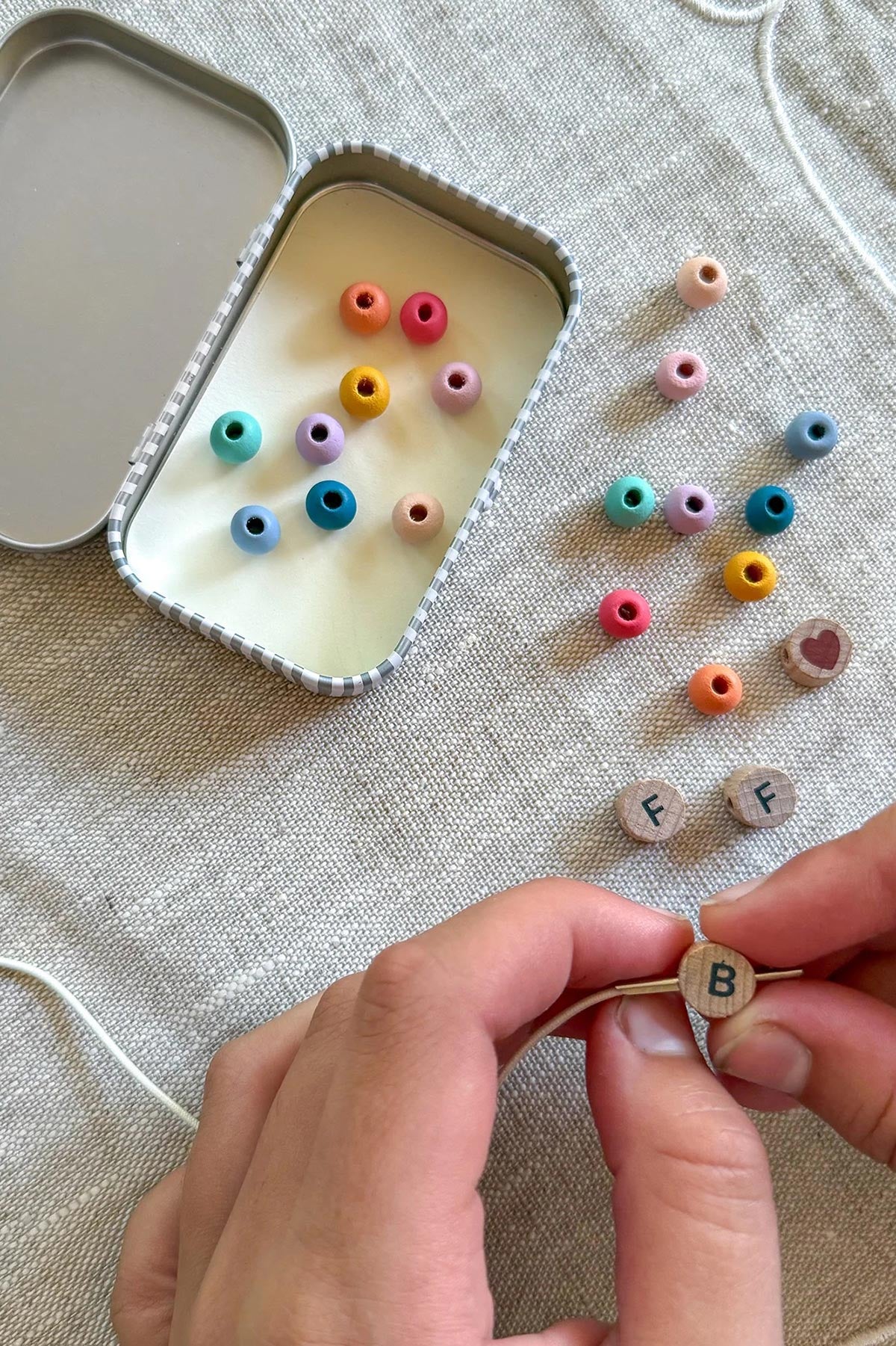Child making friendship bracelets with Cotton Twist kit