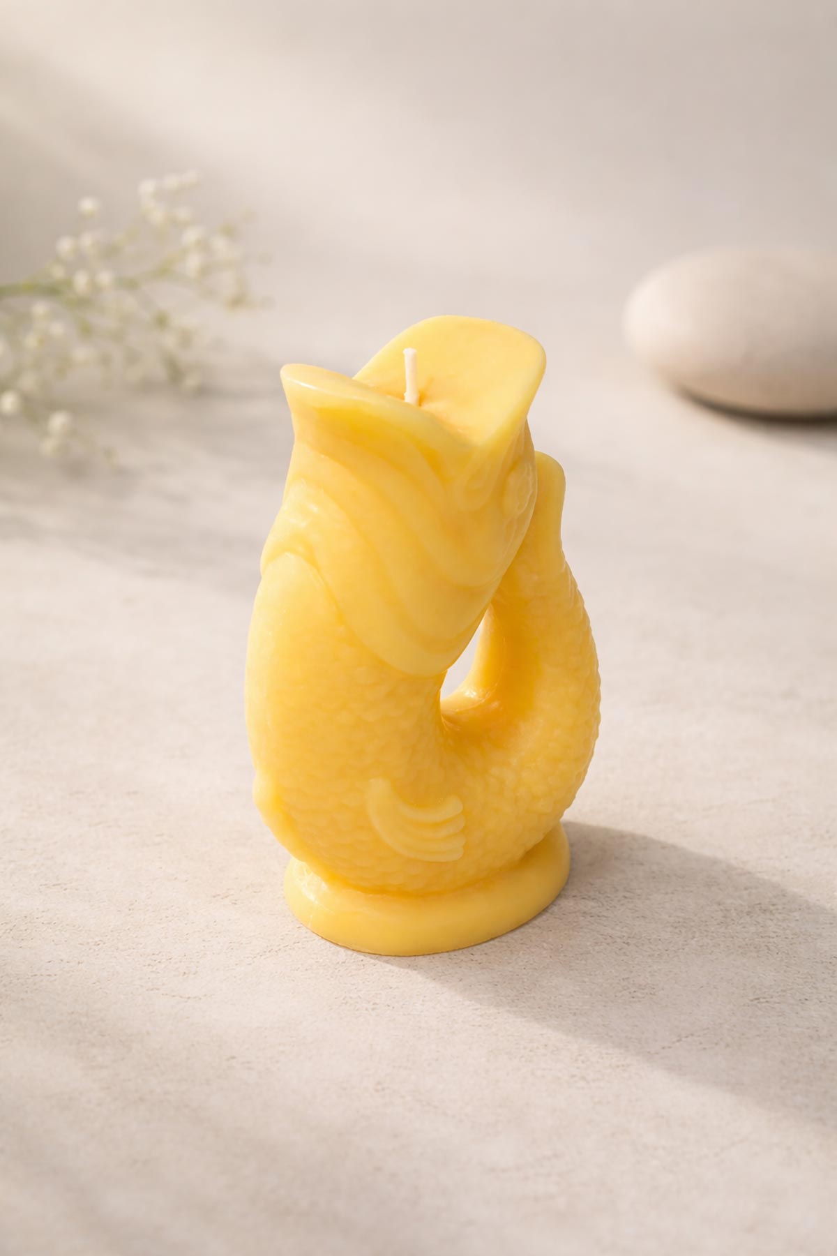 Side view of yellow Gluggle Jug Candle with sculptural fish shape