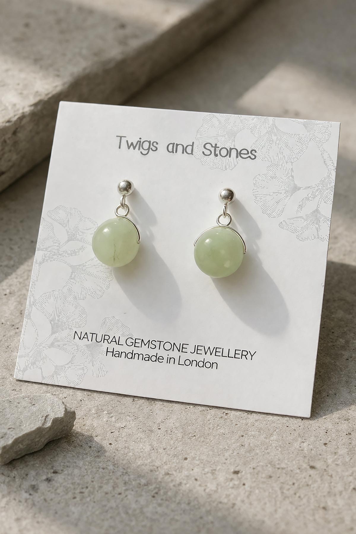 Close-up of green jade gemstone stud earrings