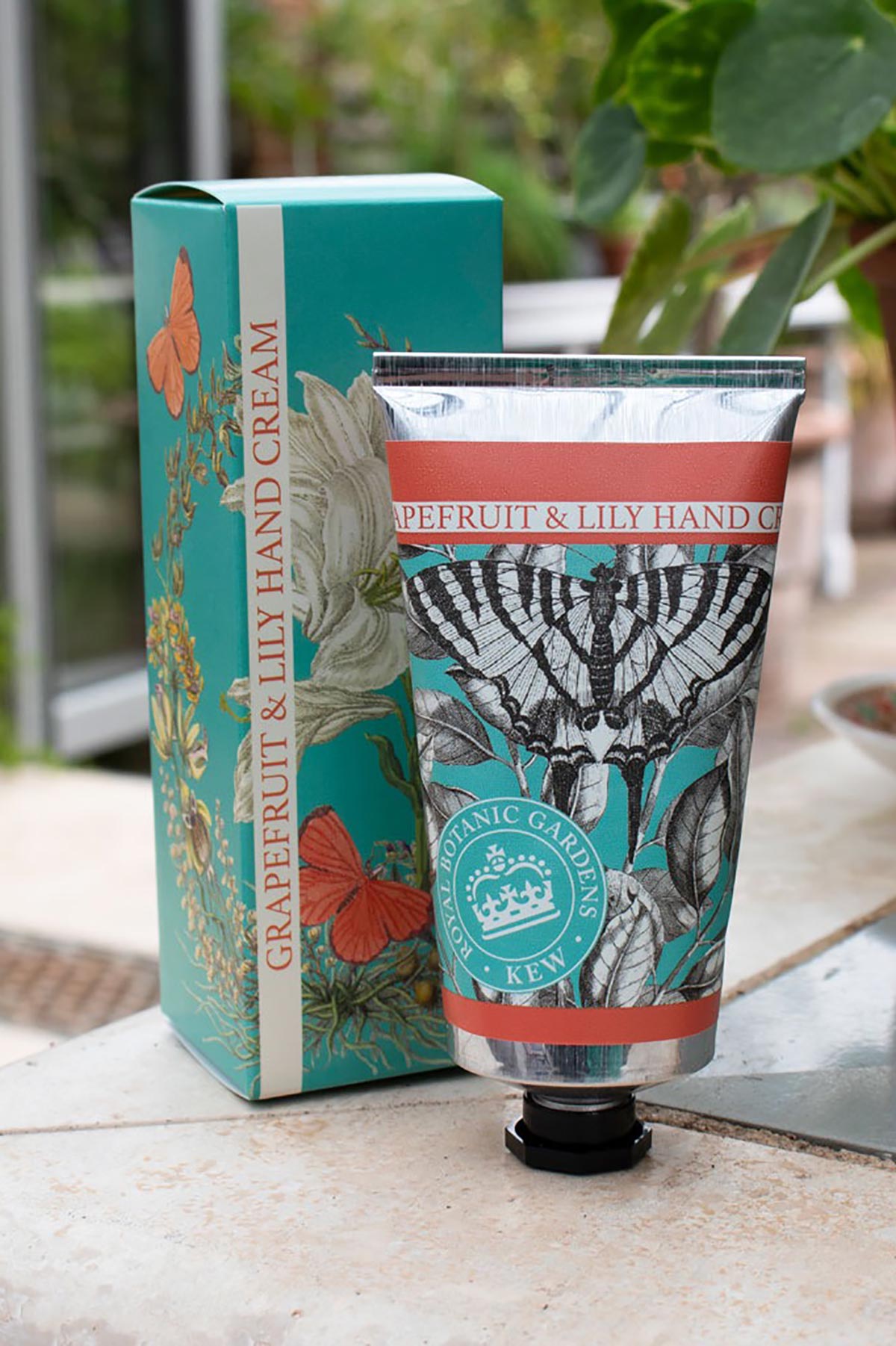 Close-up detail of Kew Gardens Grapefruit and Lily Hand Cream floral tube design